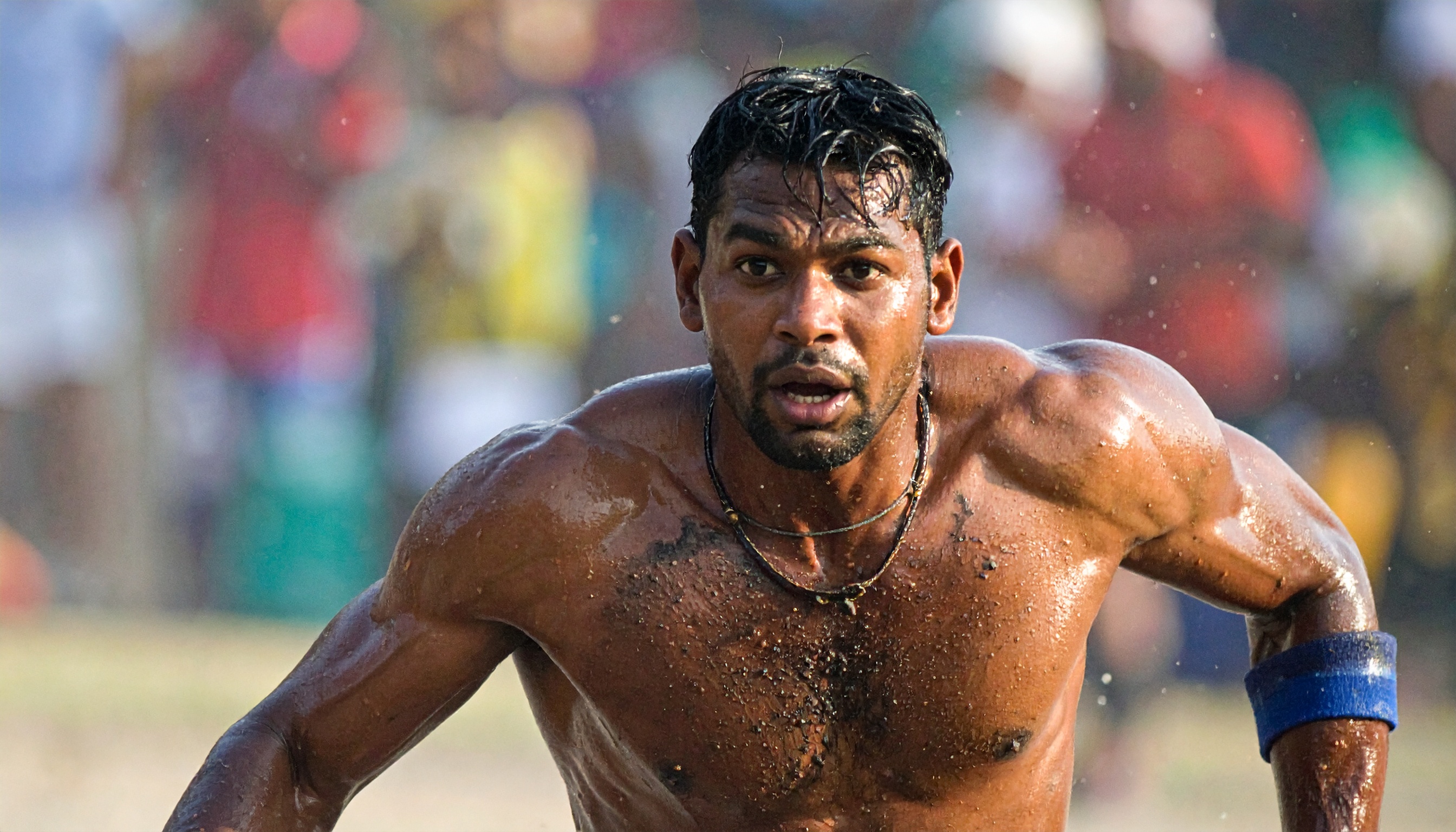 A focused athlete running with determination and intensity