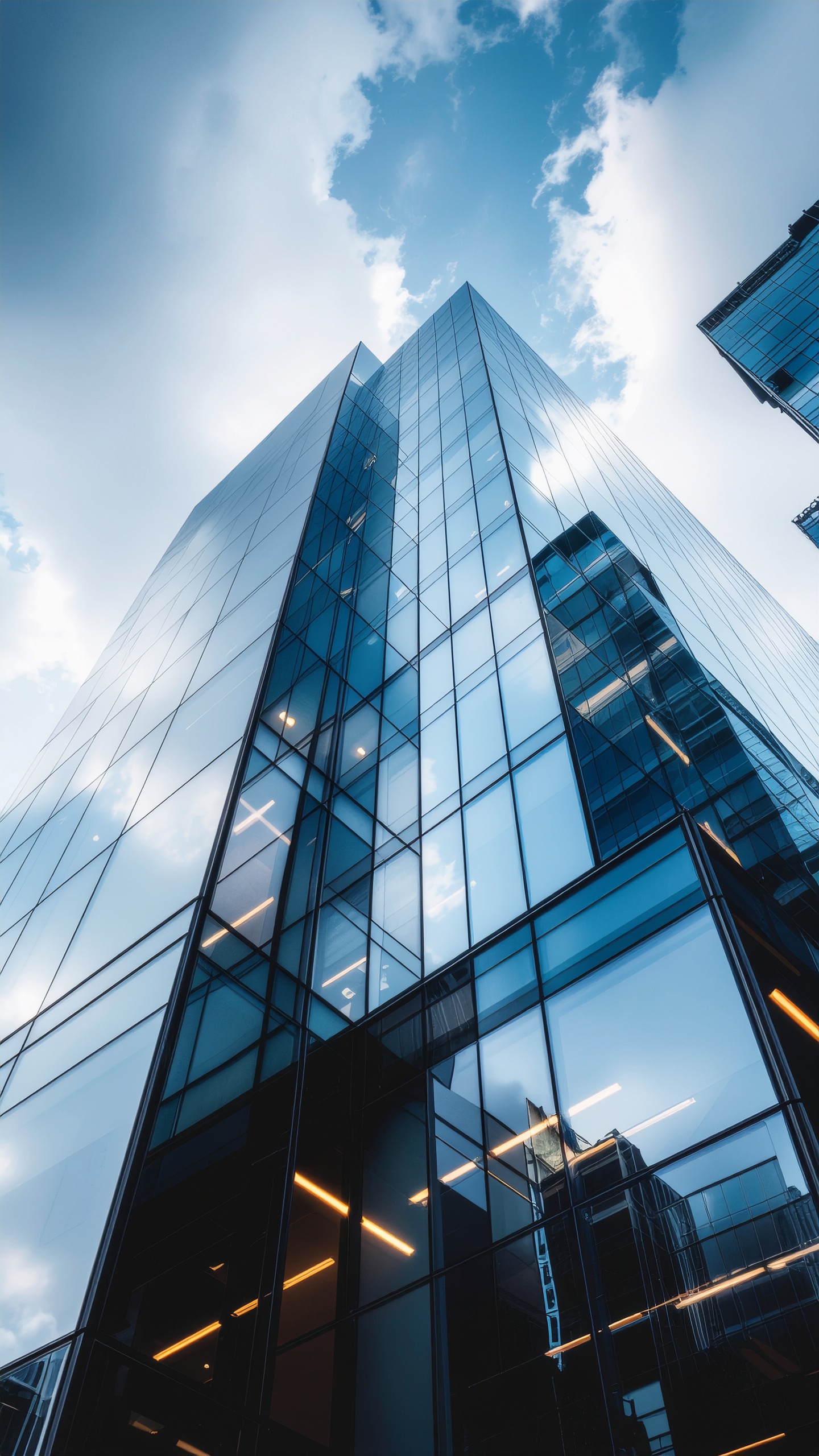 Modern Skyscraper with Glass Facade Reflecting Blue Sky