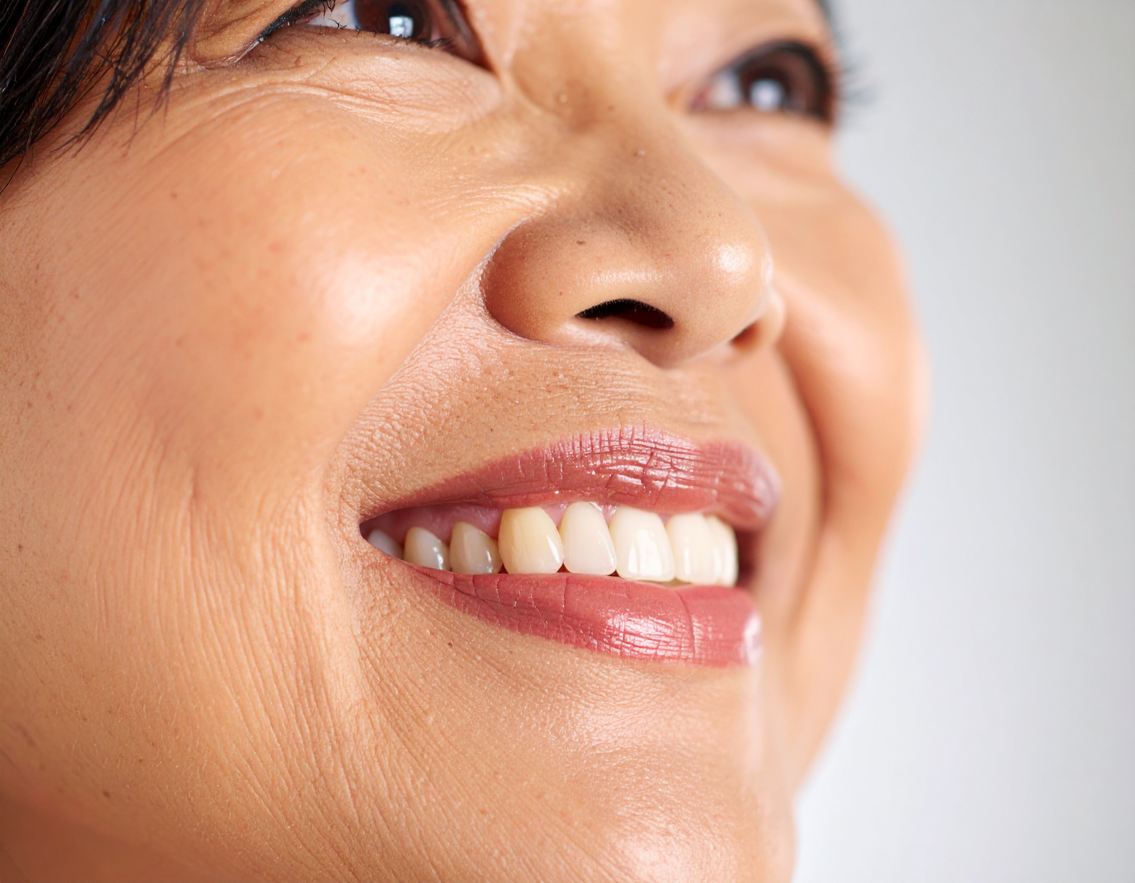 Close-up of a woman's radiant smile and healthy skin