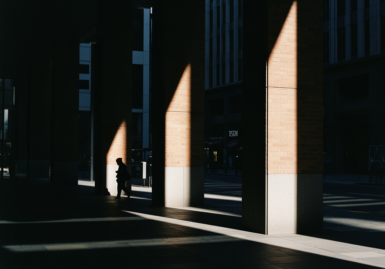 Shadows cast by tall pillars create a striking urban silhouette