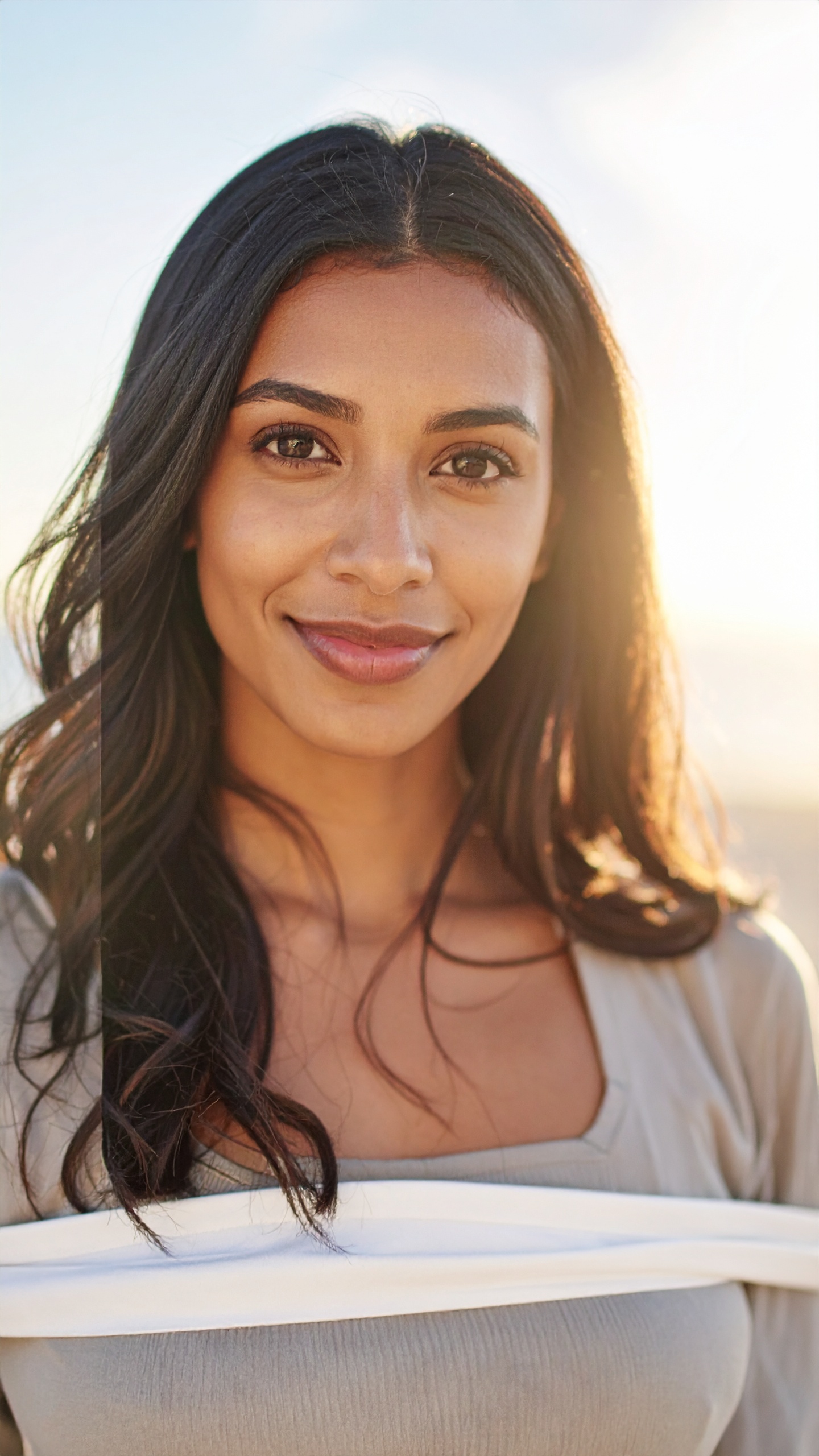 A serene portrait of a woman basking in sunlight outdoors