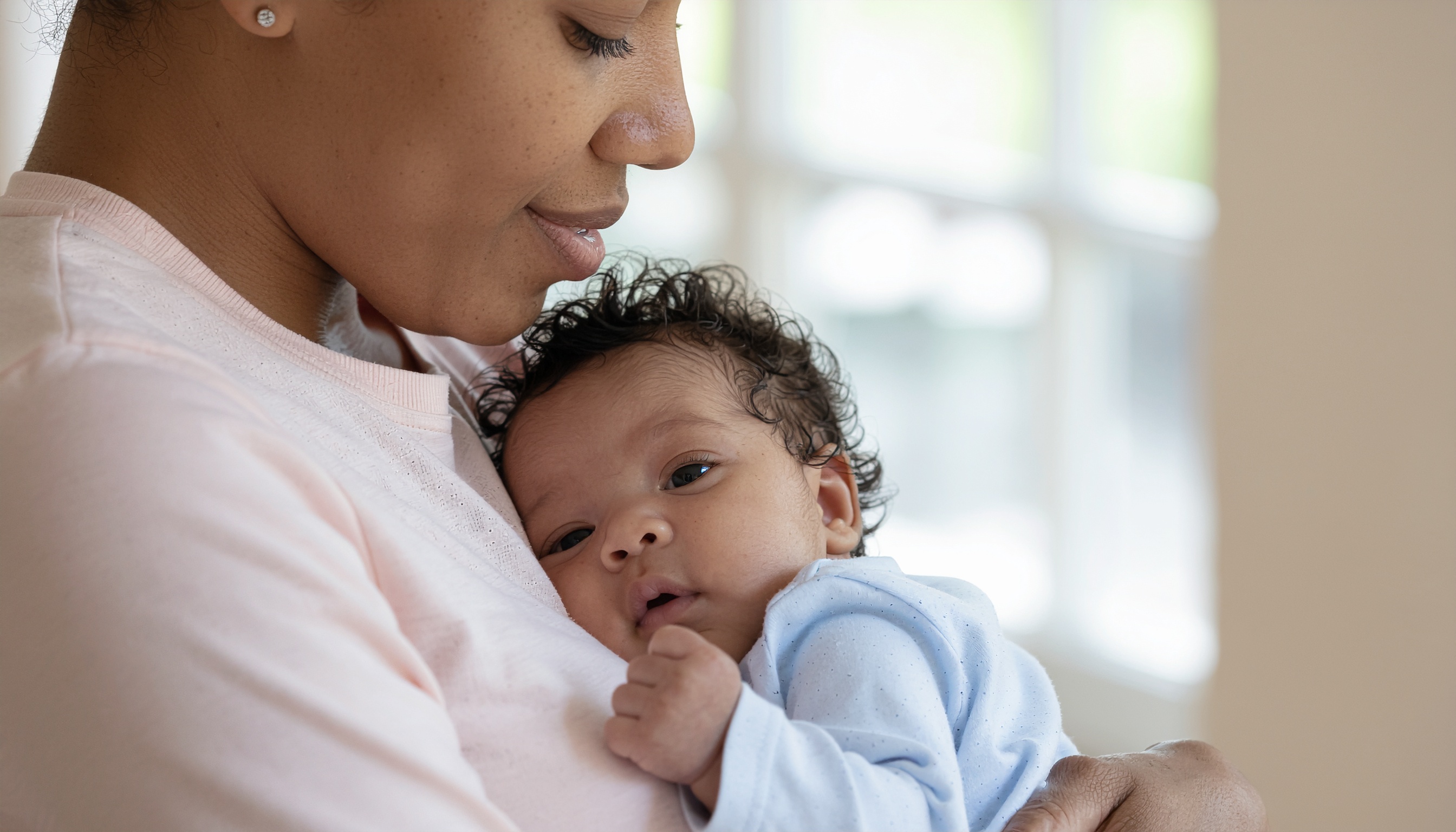 Portrait of a Woman Holding a Baby in Natural Light