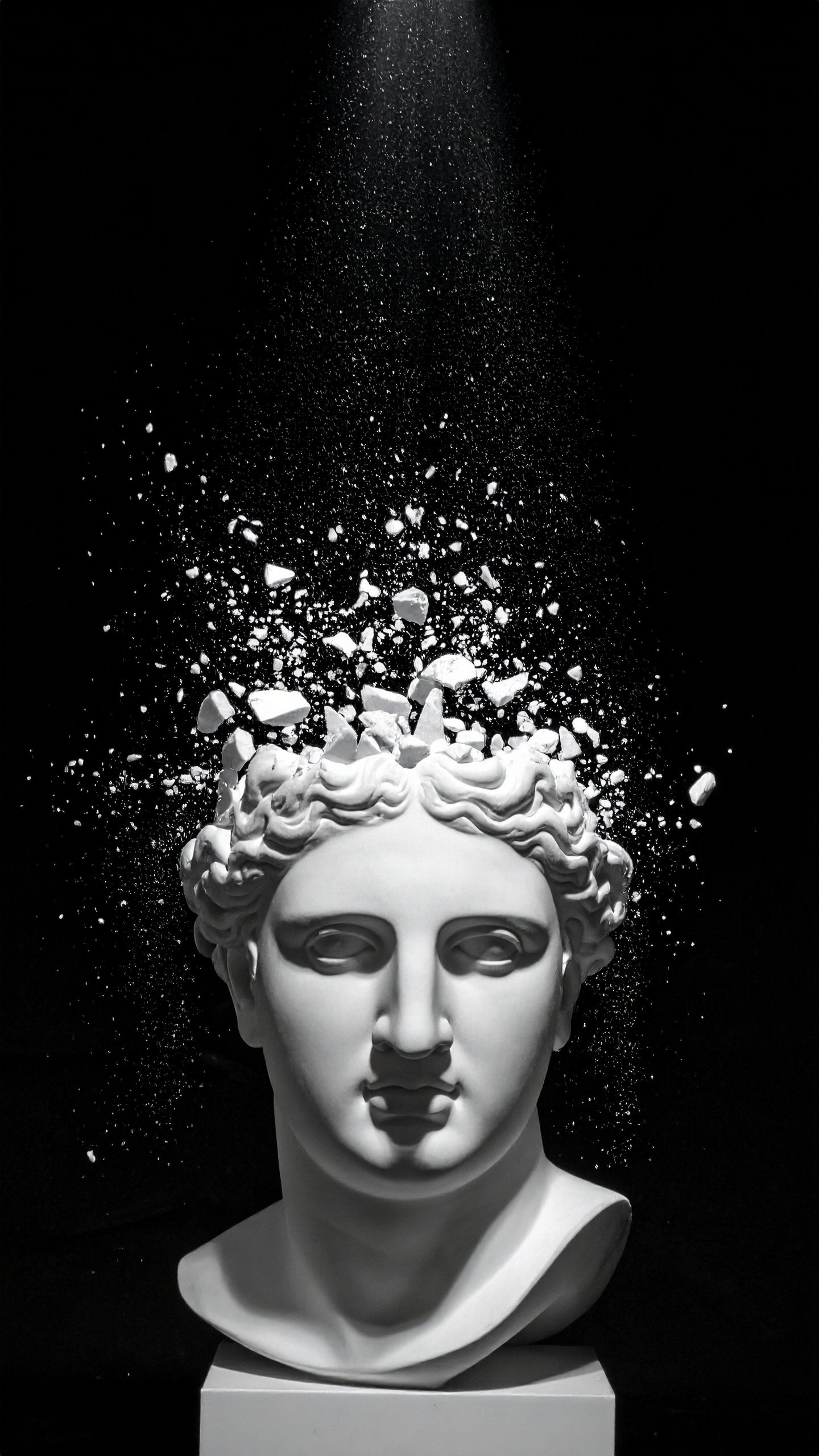 A white marble bust with fragments exploding from the top creates a striking visual against