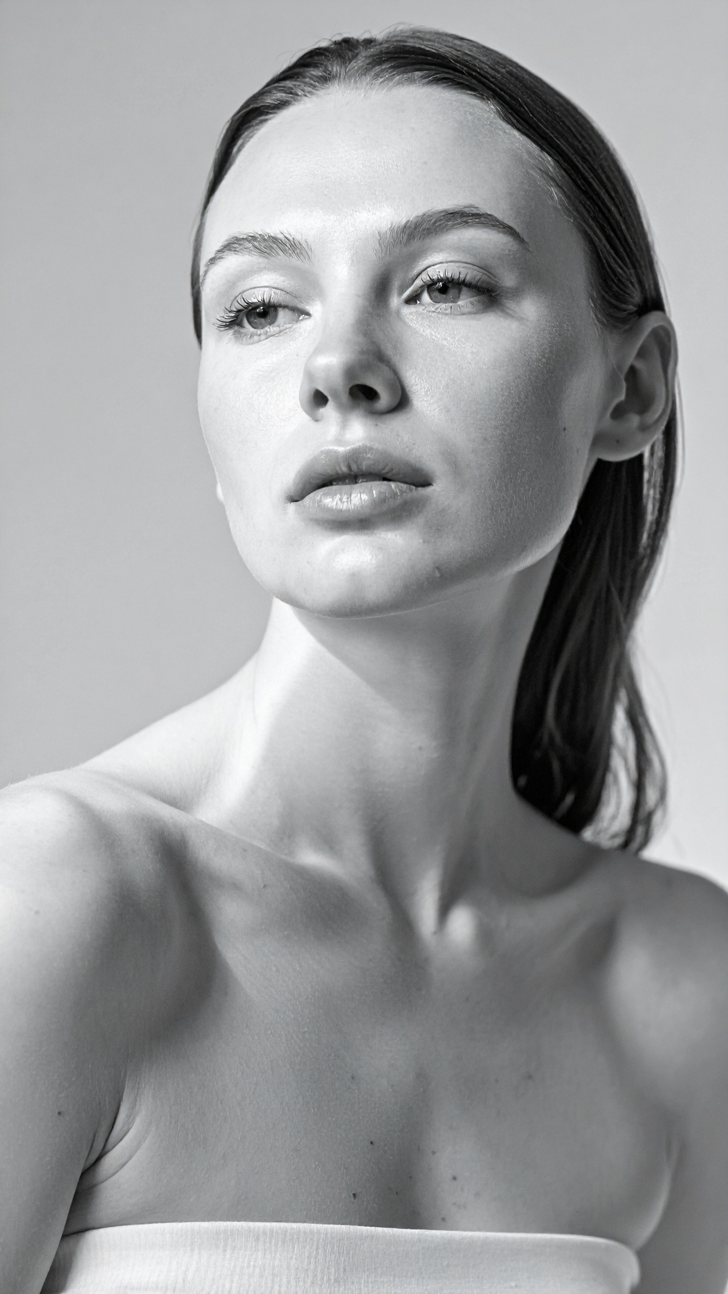 A monochrome portrait of a woman with a serene expression and clean lines