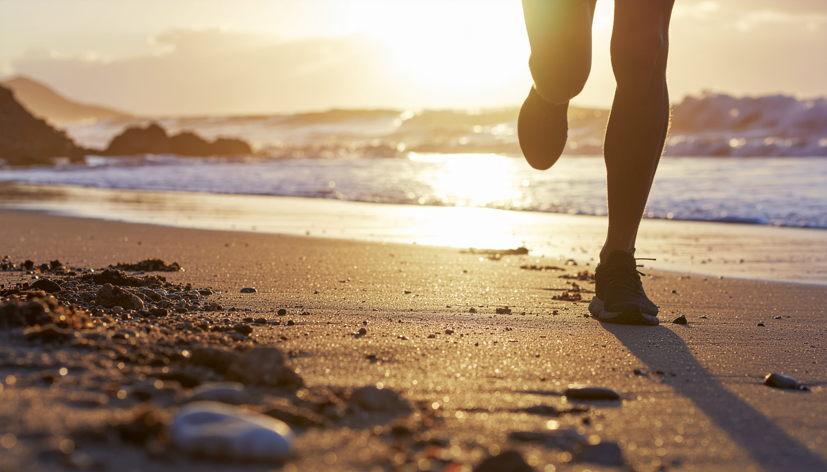 Person Running on Beach at Sunset