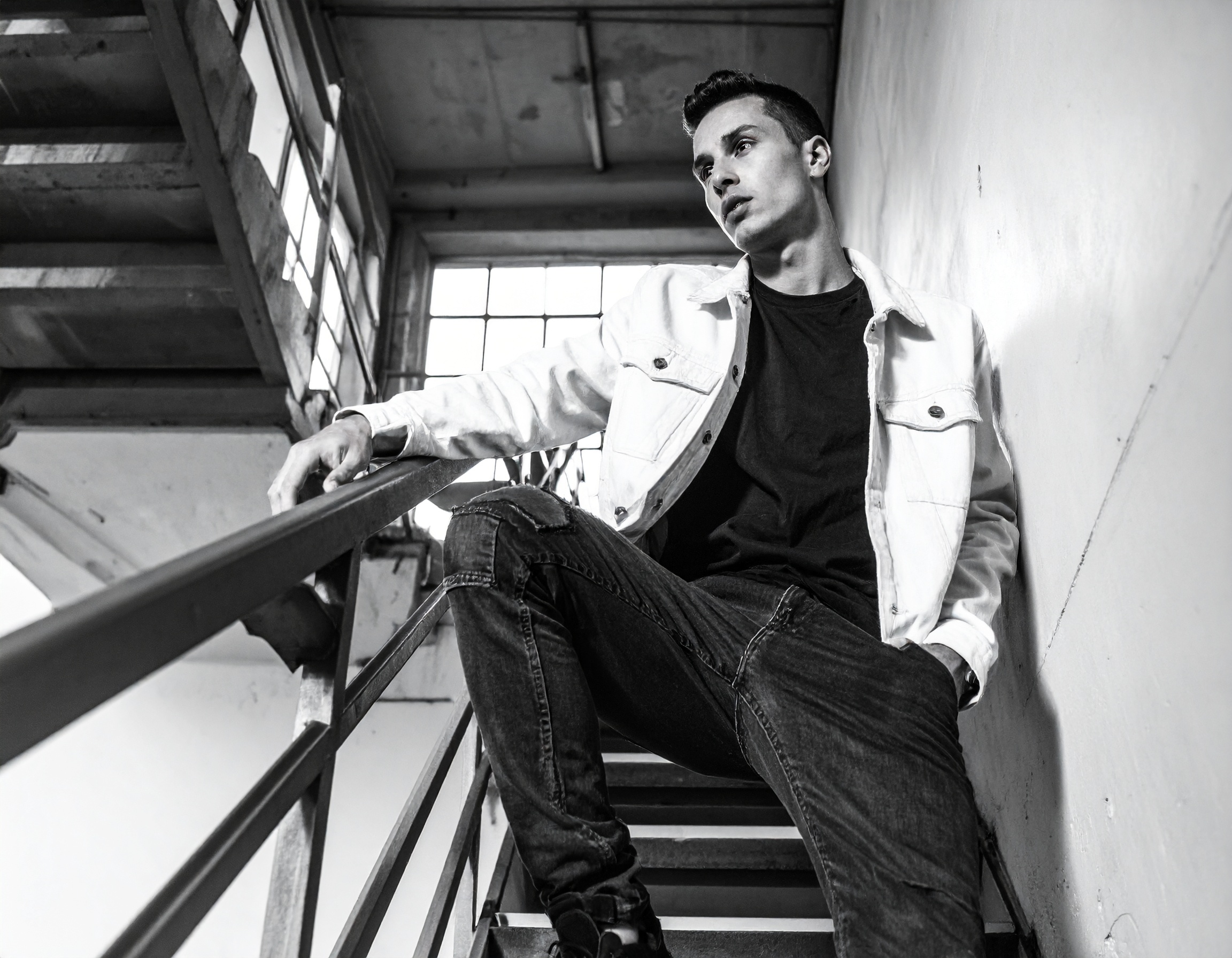 Black and White Portrait of a Man on an Industrial Staircase