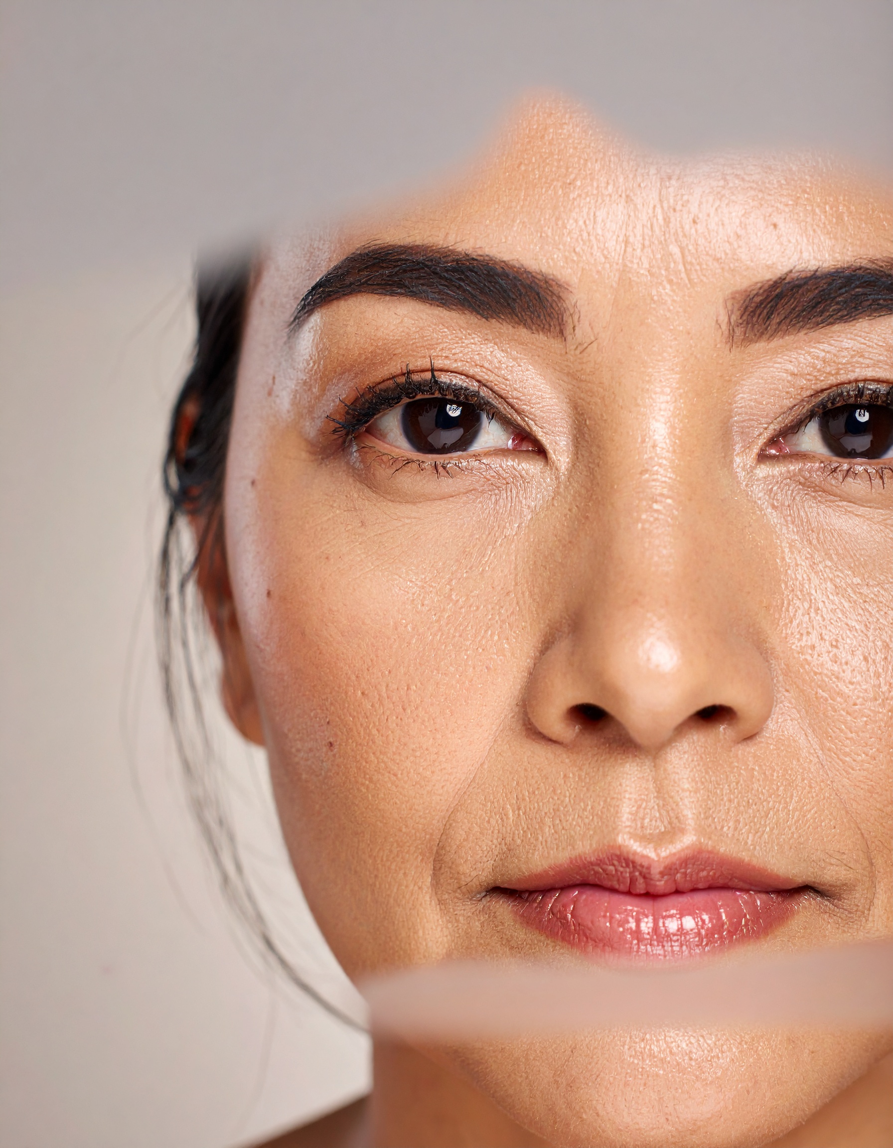 A close-up of a woman's face highlights the natural texture of her skin