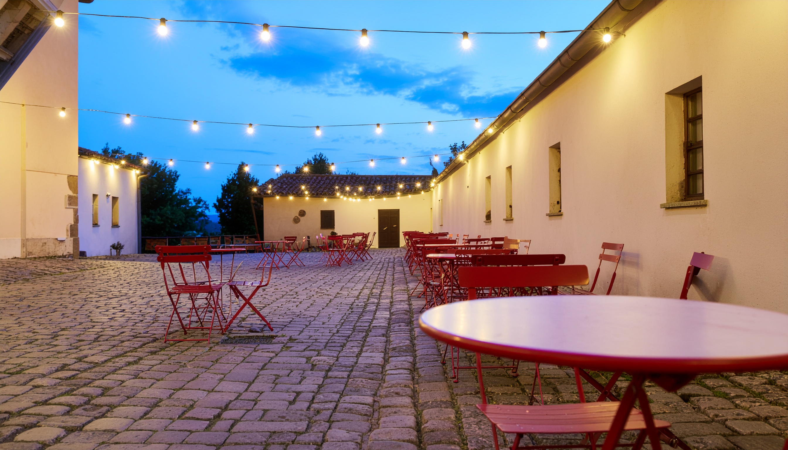 Outdoor Patio with Red Tables and Chairs