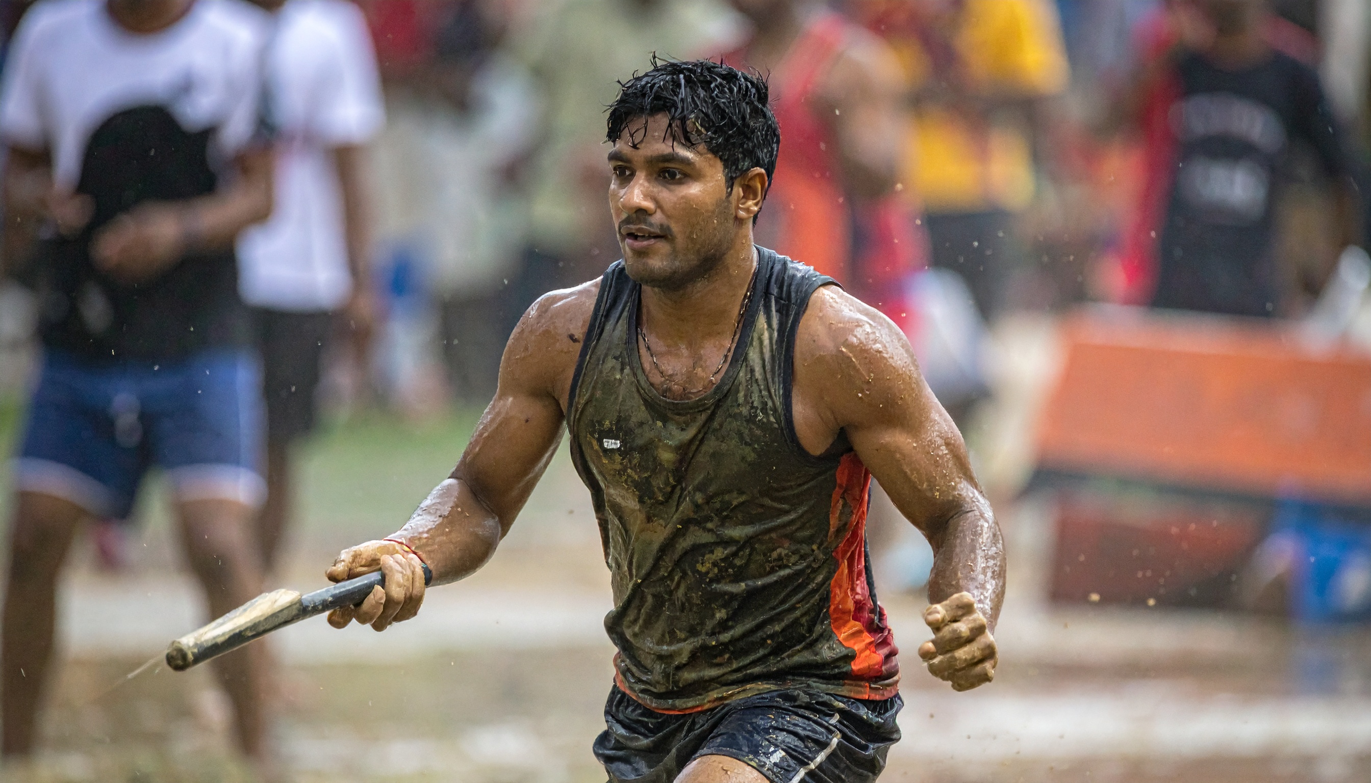 A determined athlete competes in a muddy outdoor event