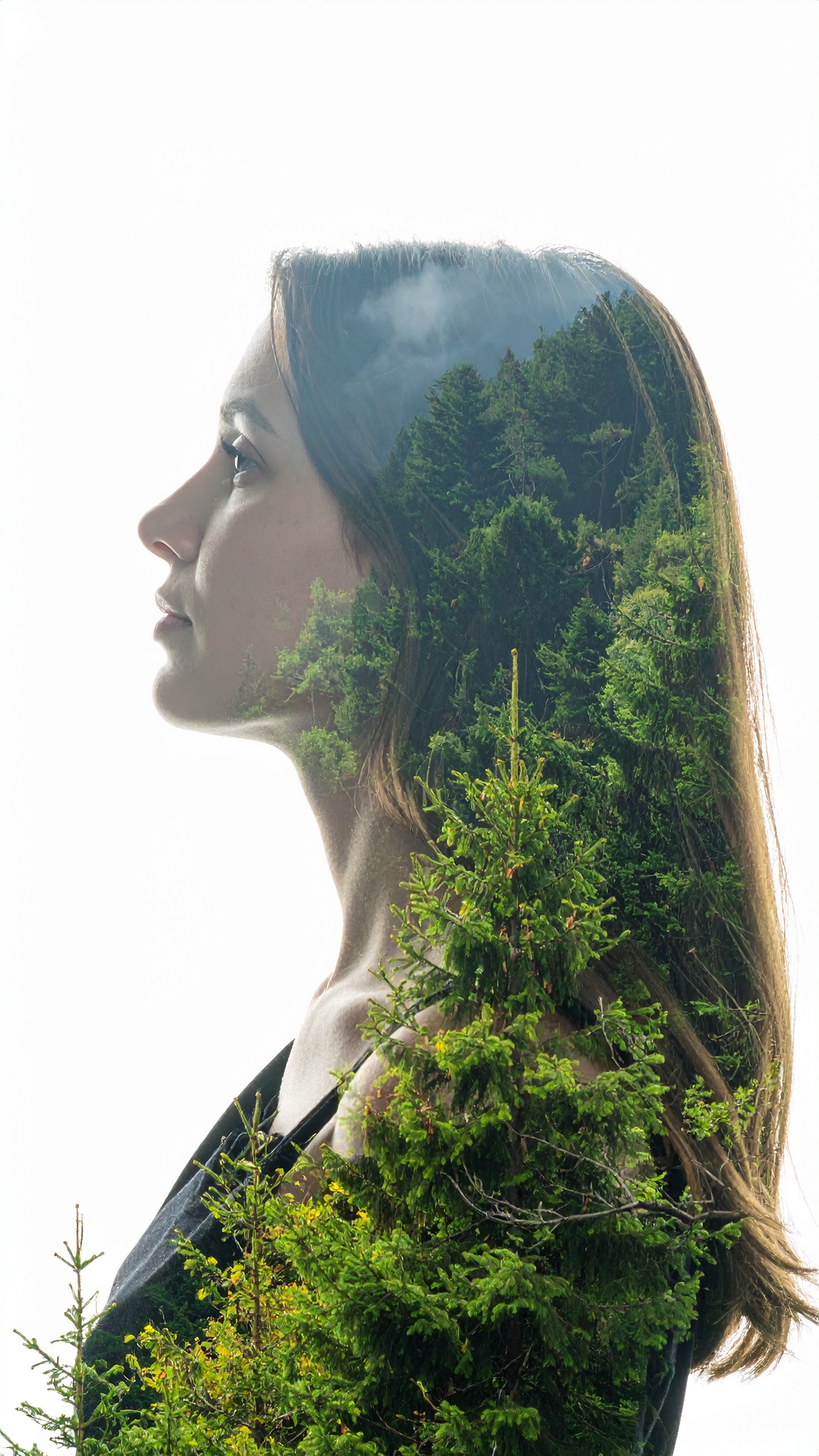 A double exposure image beautifully blends a woman's profile with a lush green forest