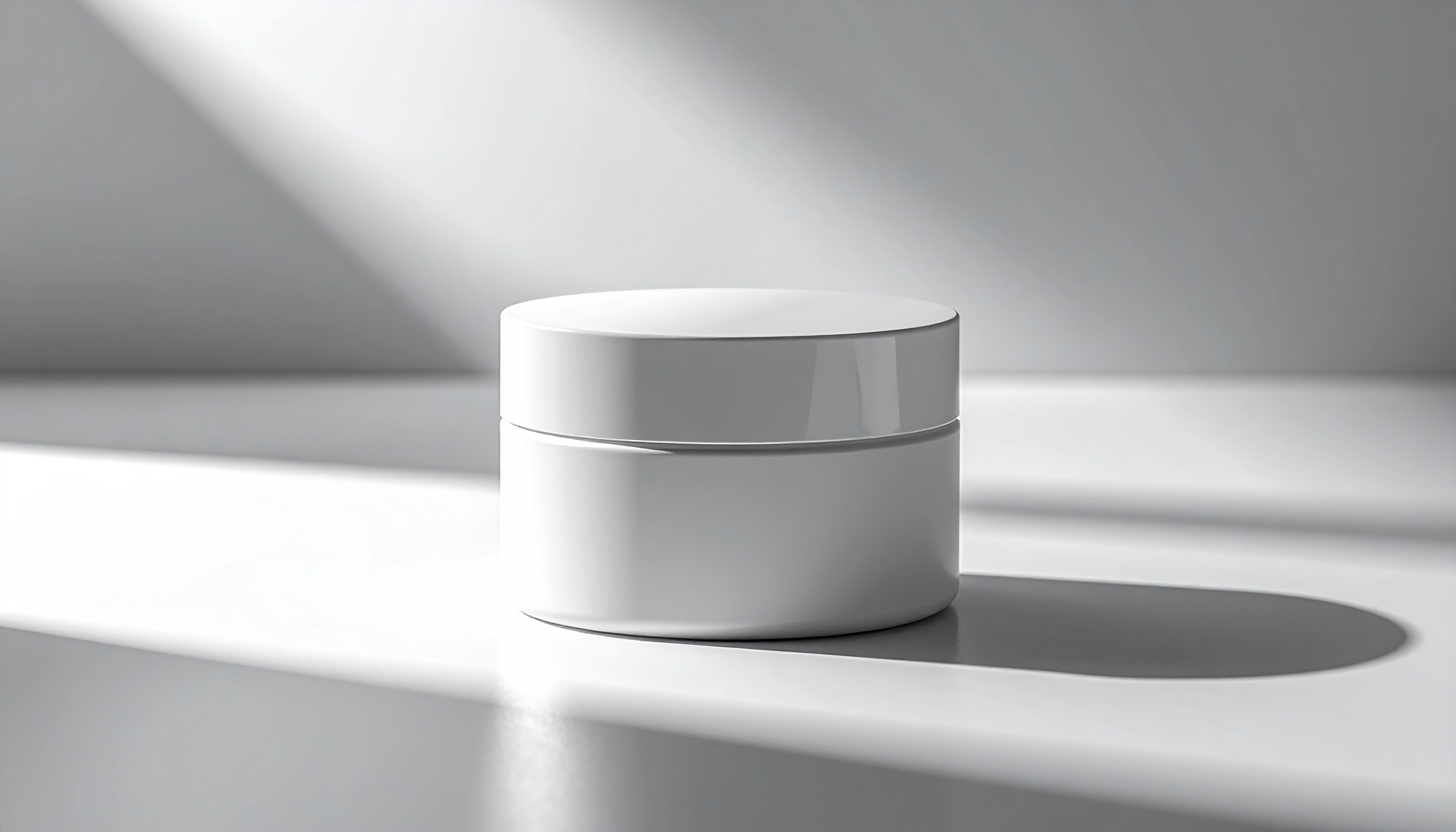 A sleek white cylindrical cosmetic jar sits elegantly on a reflective surface