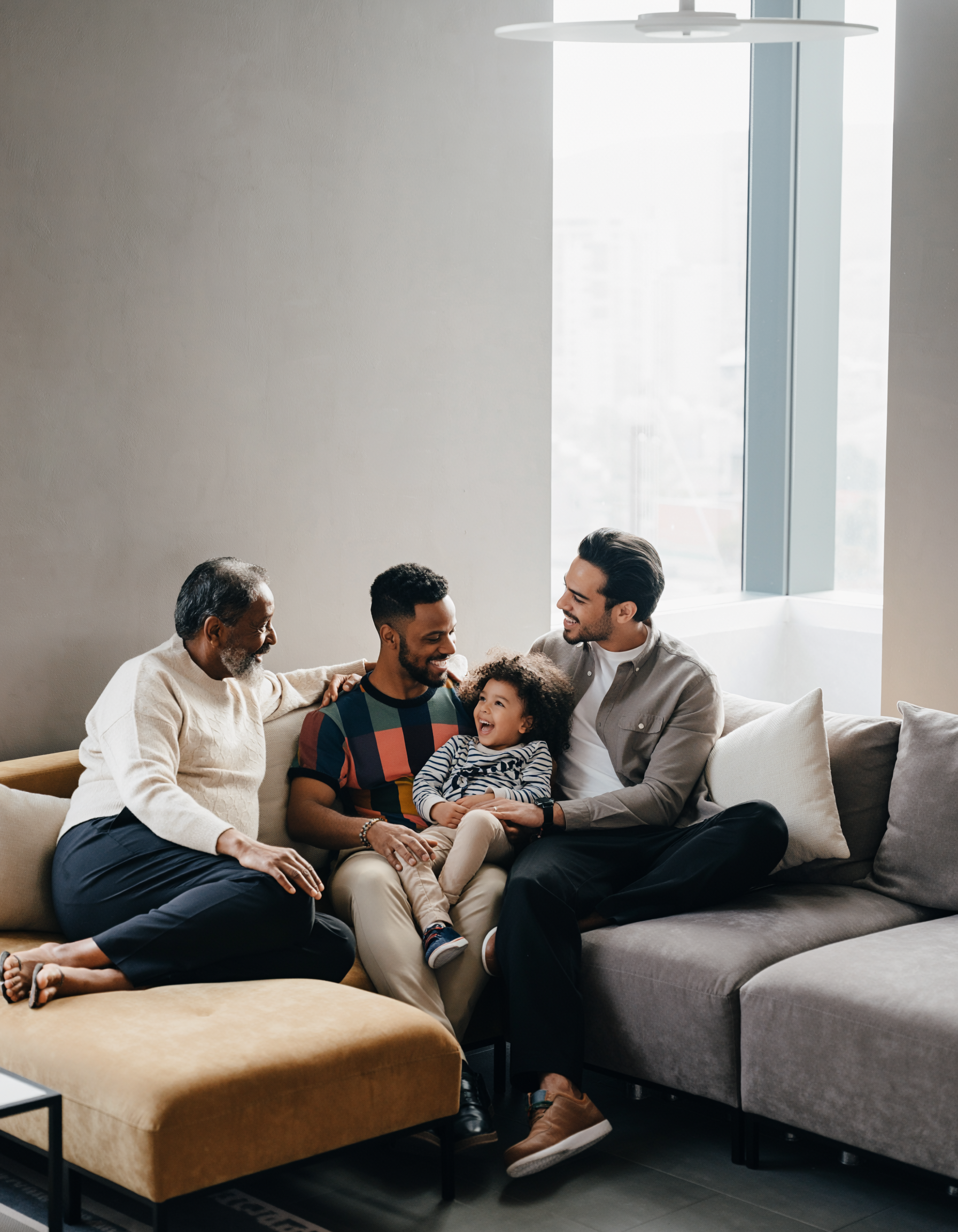 Warm Family Scene with Four People on a Modern Sofa