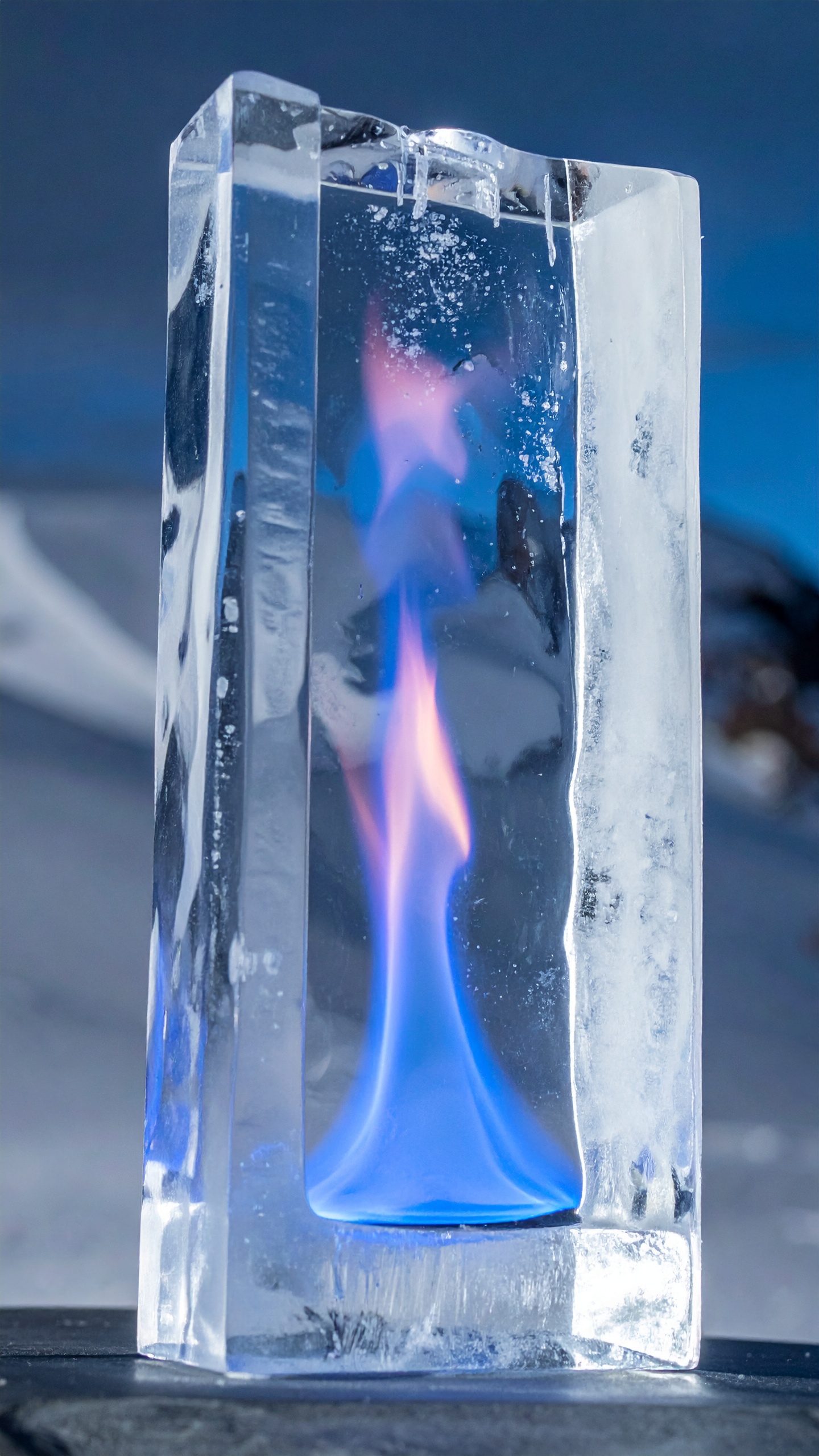A mesmerizing ice sculpture encases a vibrant blue flame, creating a stunning visual contrast
