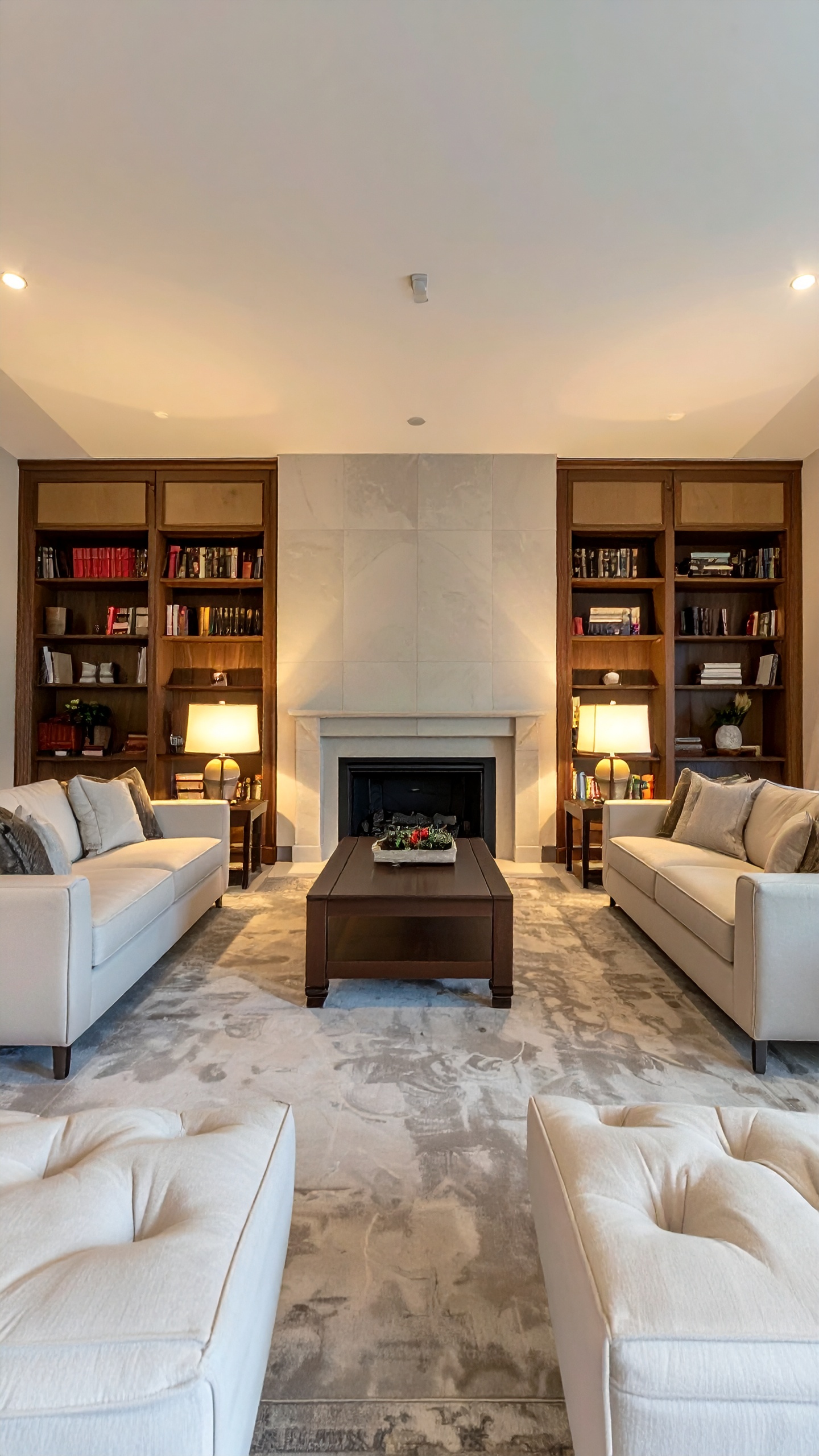 A sophisticated living room features elegant beige sofas and a central coffee table
