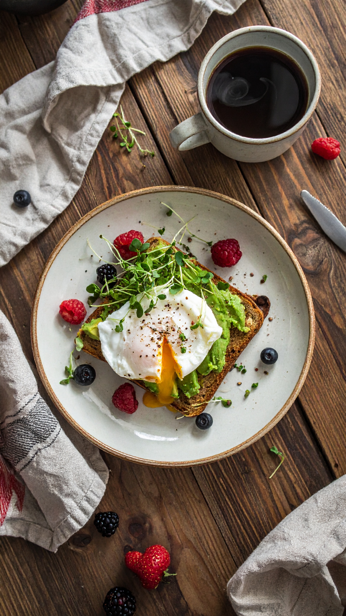 A delicious breakfast of avocado toast topped with a perfectly poached egg