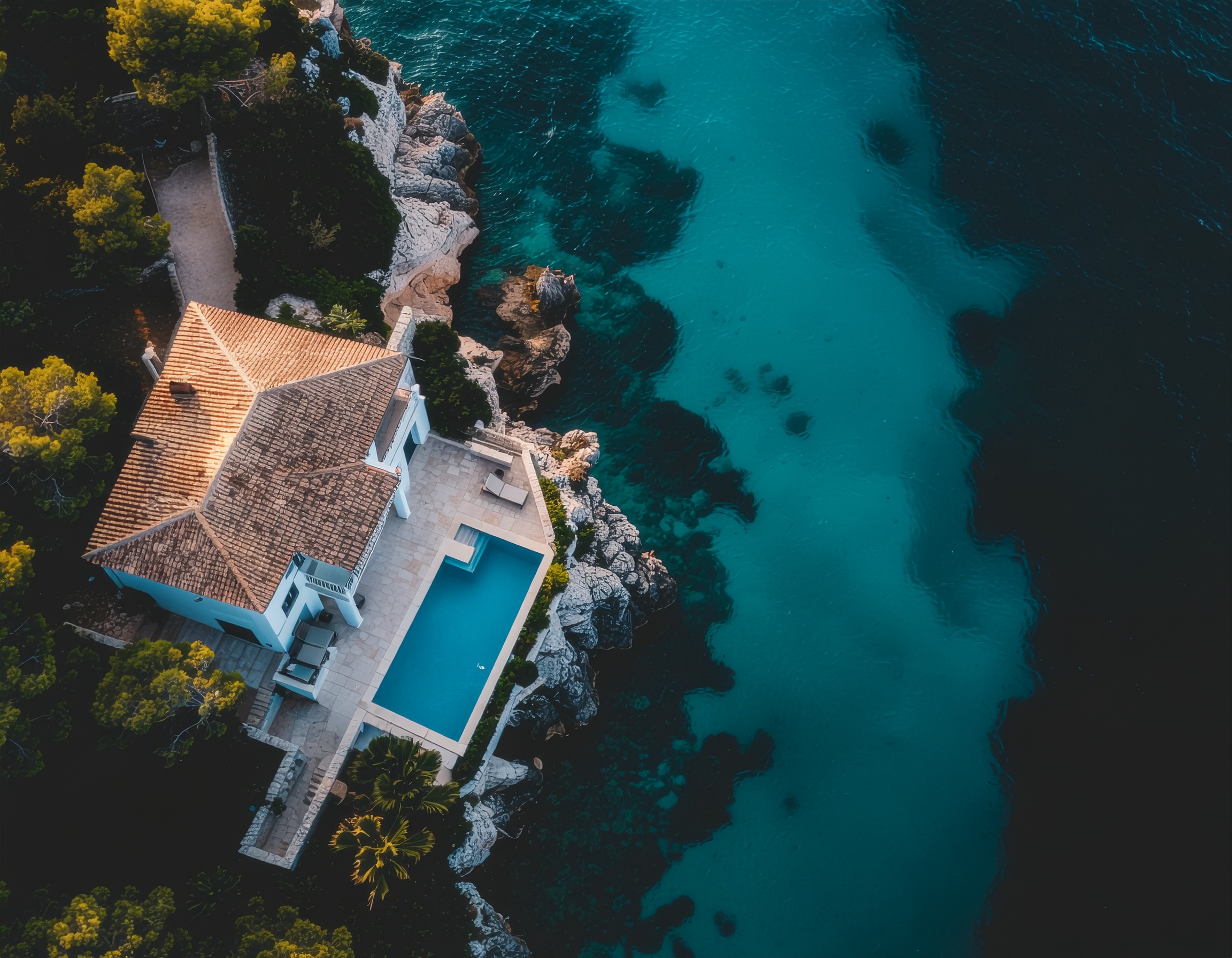 Aerial View of a Modern House with Pool on Rocky Cliff