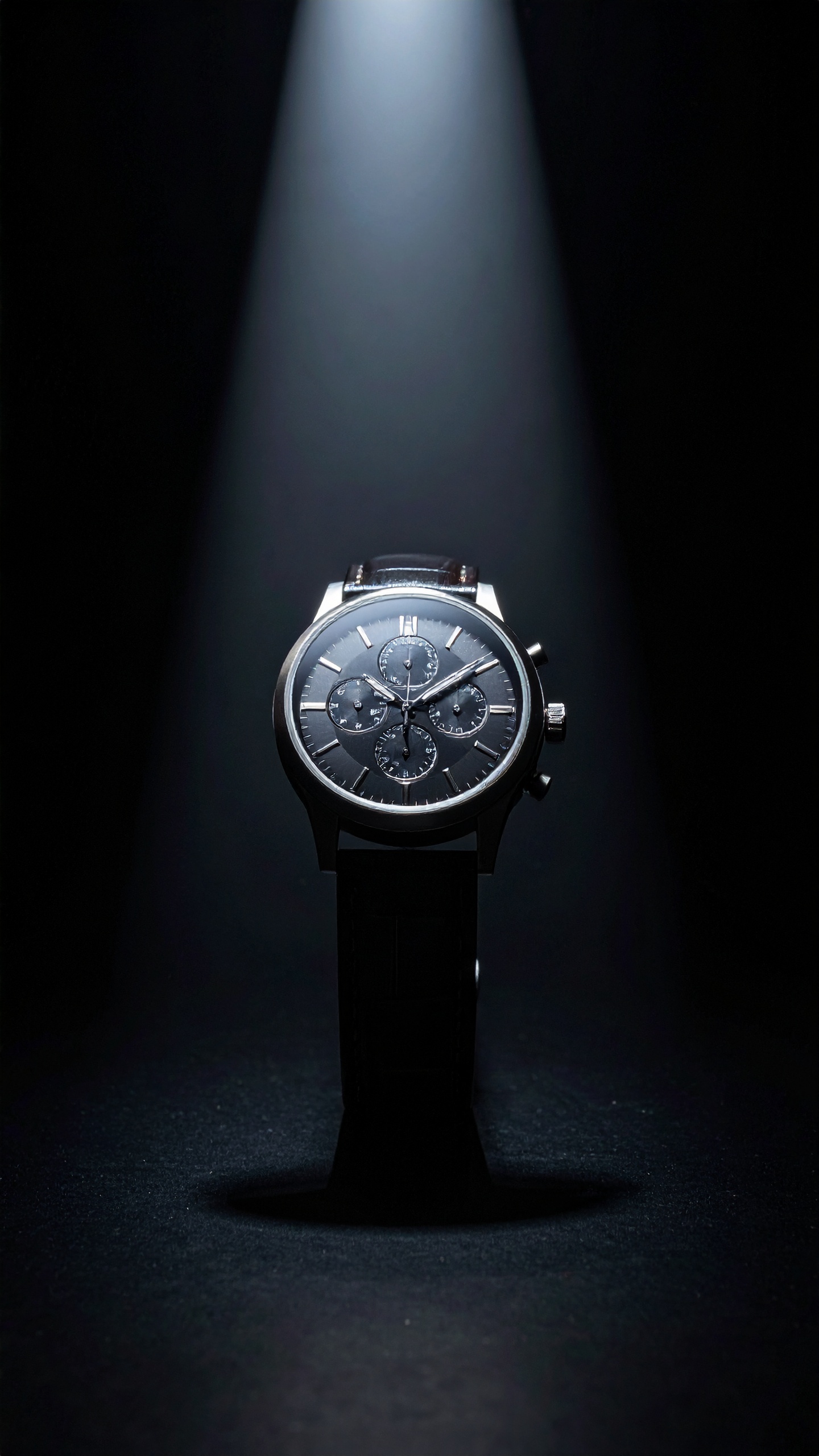 A sleek, luxury watch is elegantly spotlighted against a dark background