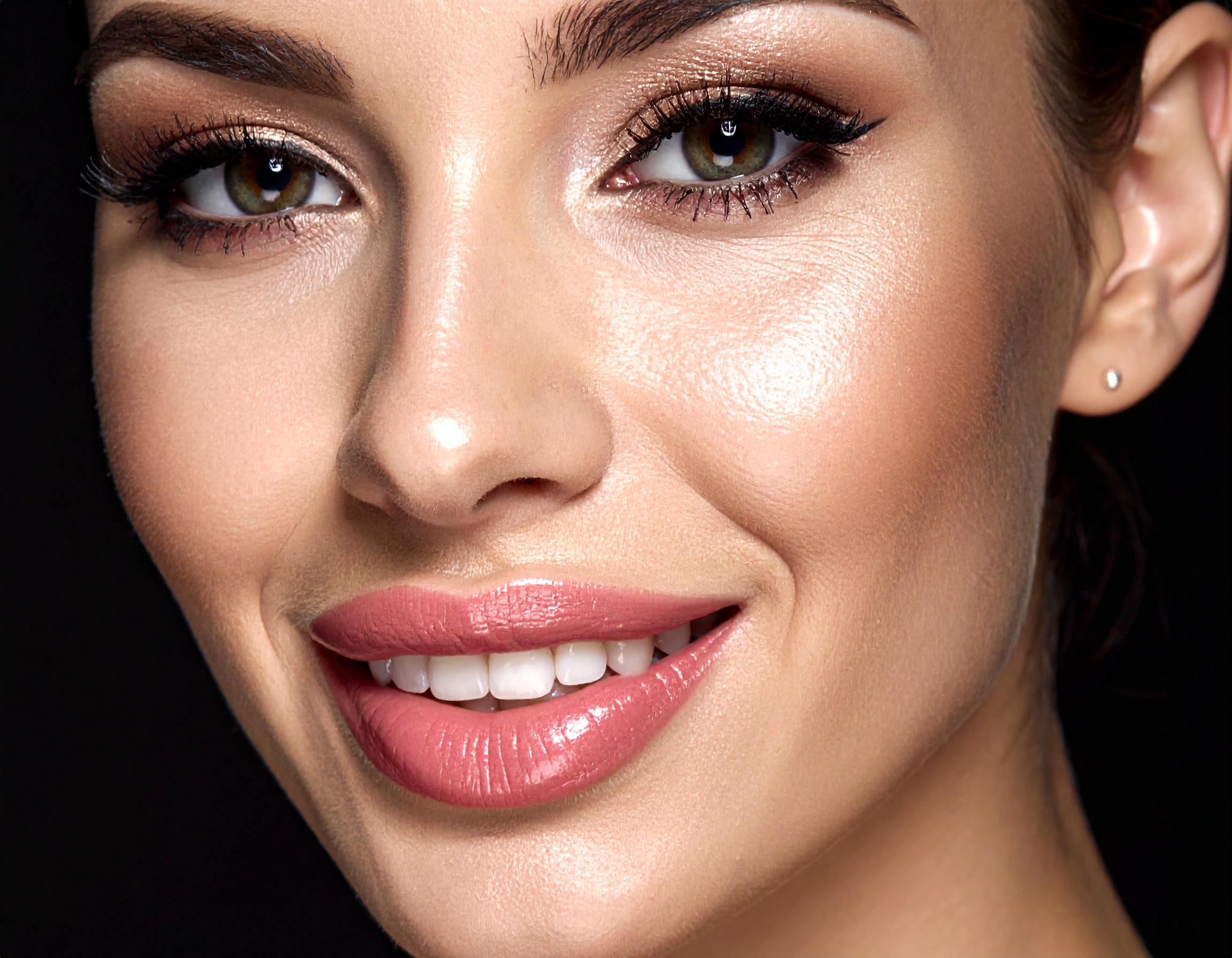 A woman's radiant face with flawless makeup highlights elegance