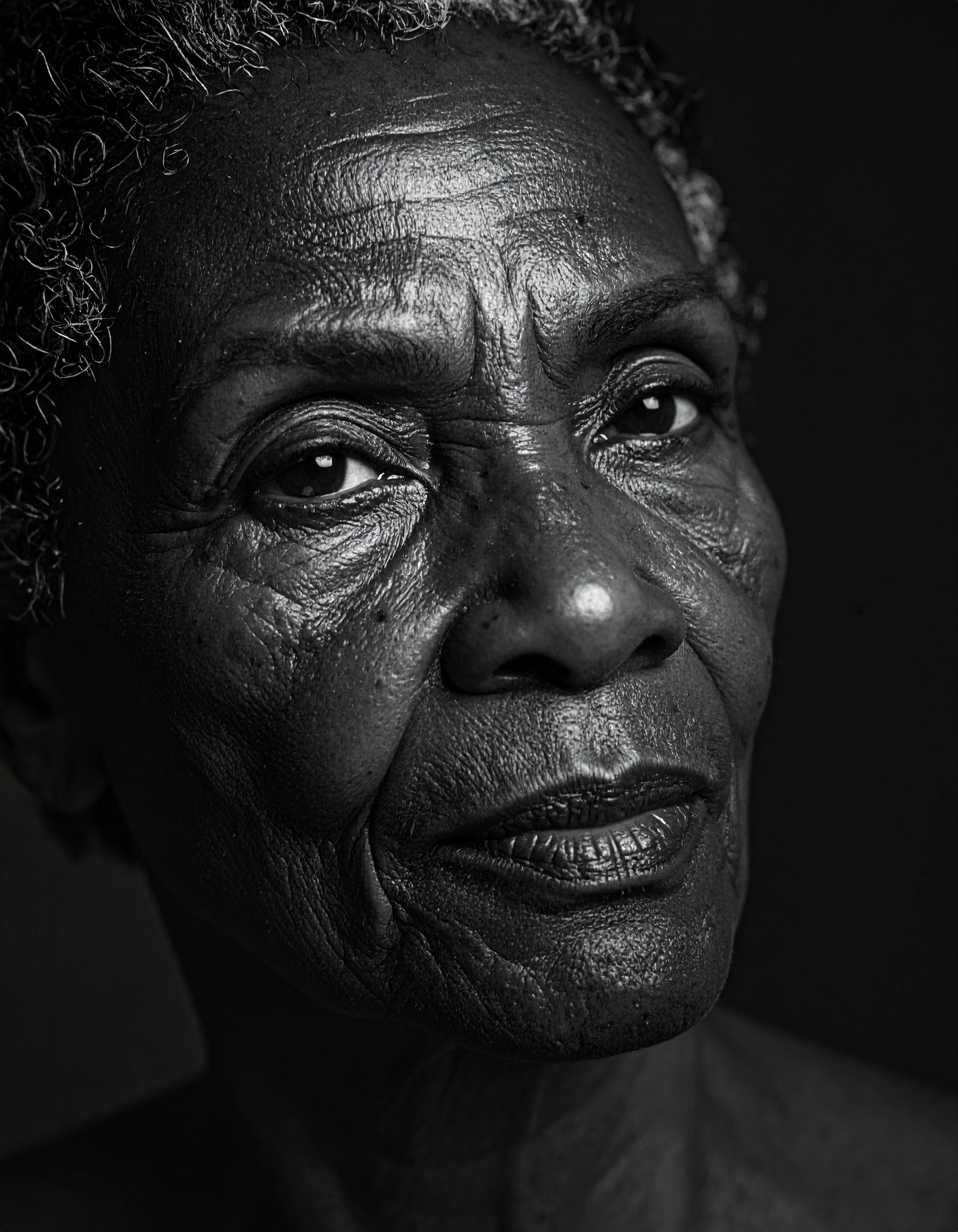 Striking black and white portrait of an elderly person with deep expression