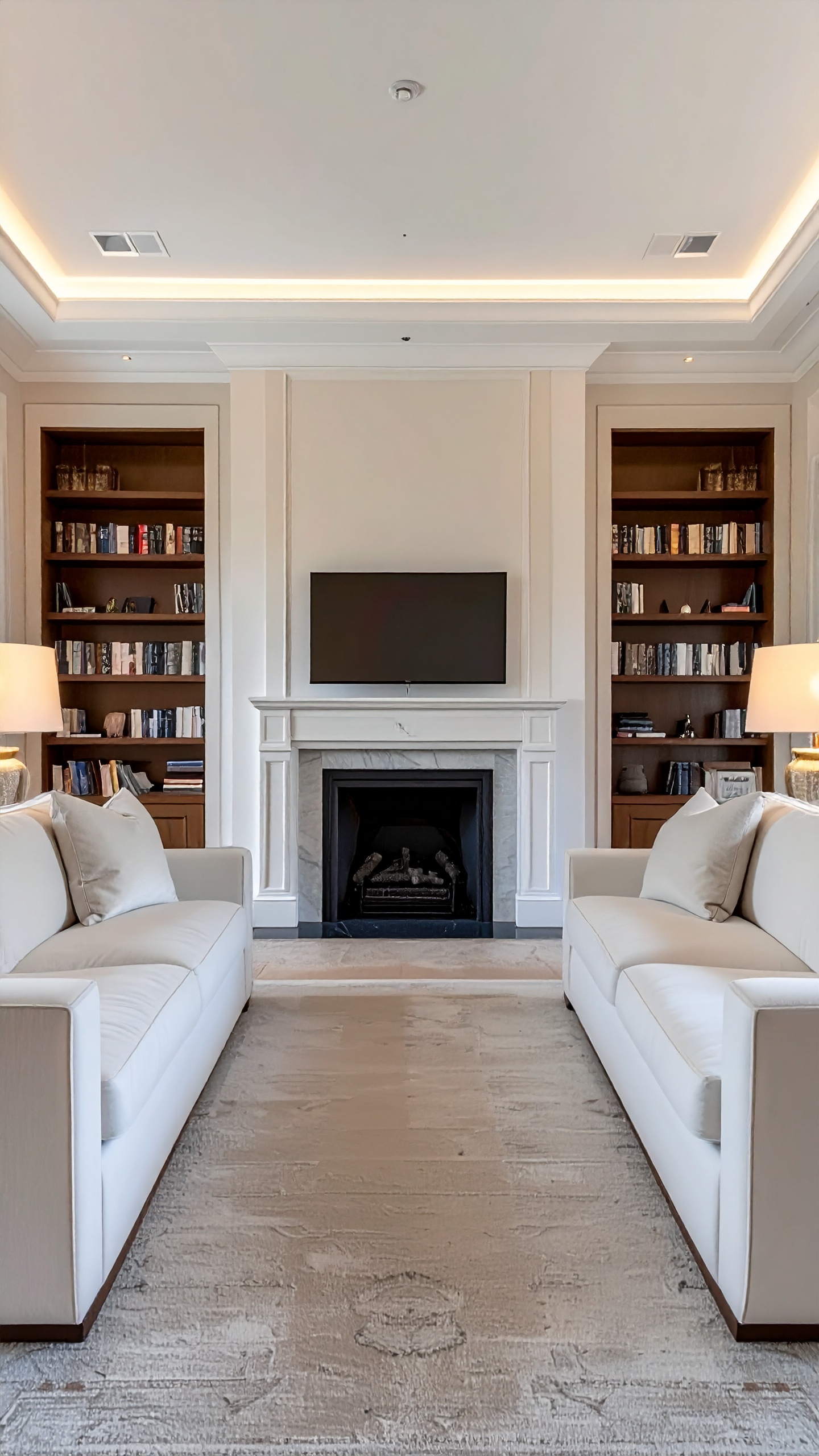 Elegant living room with symmetrical design featuring two white sofas facing each other