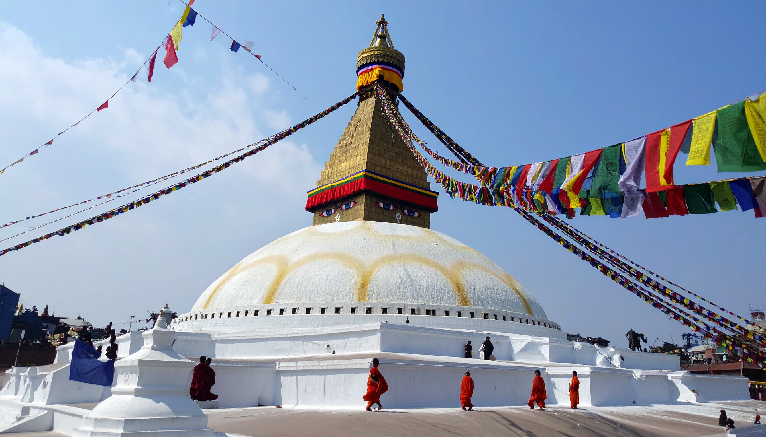 The Boudhanath Stupa stands majestically under a clear blue sky