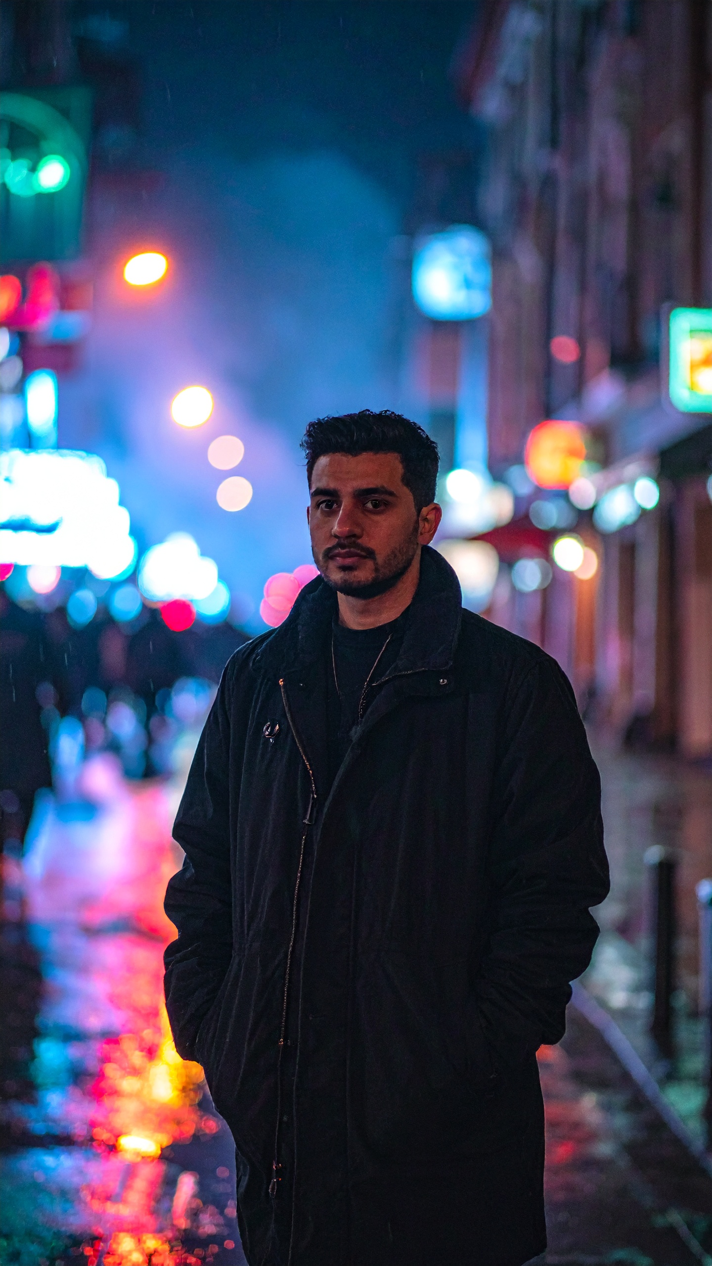 Man in Dark Jacket on Urban Street at Night