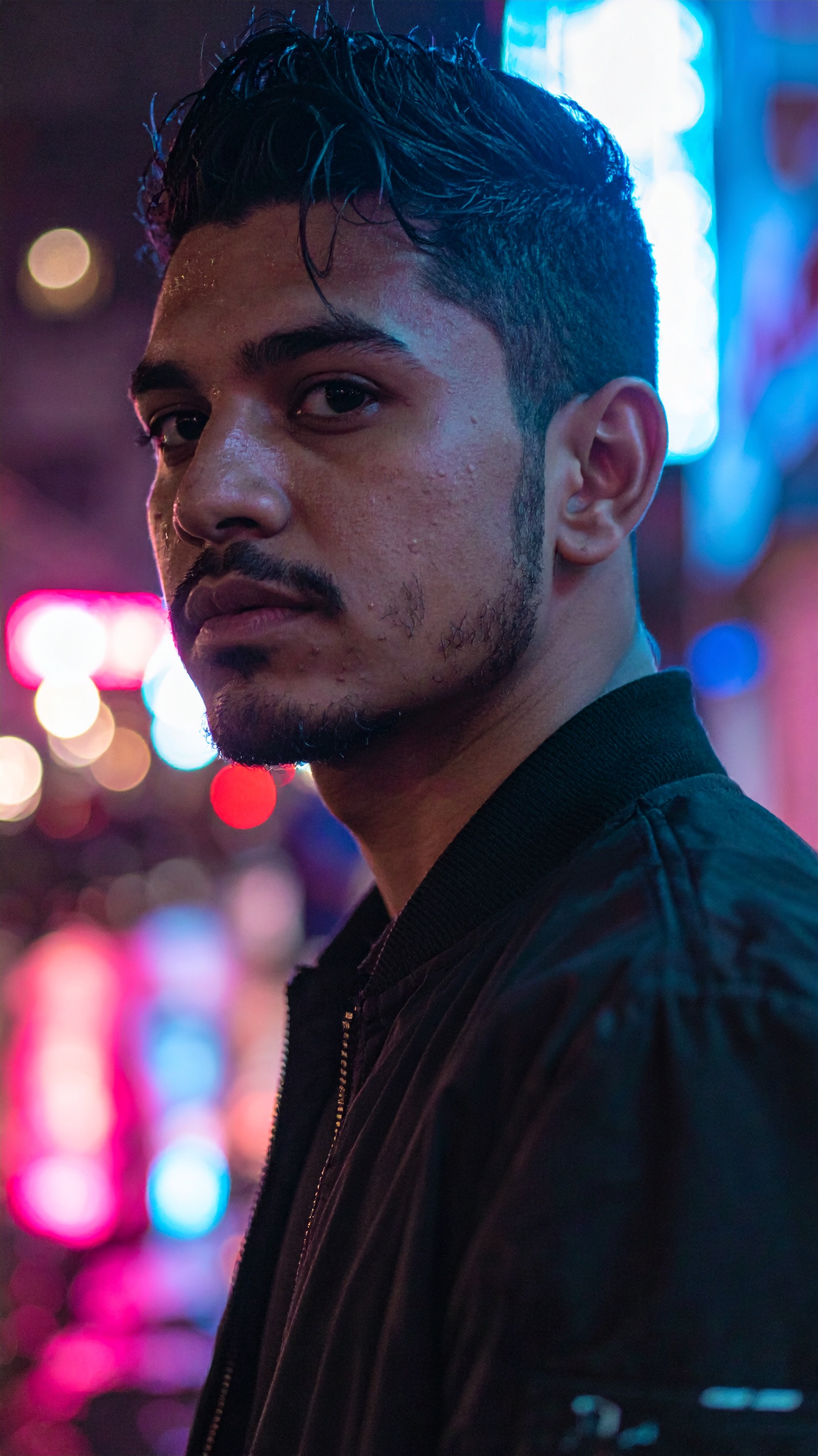 Young Man Portrait in Vibrant Neon Urban Night