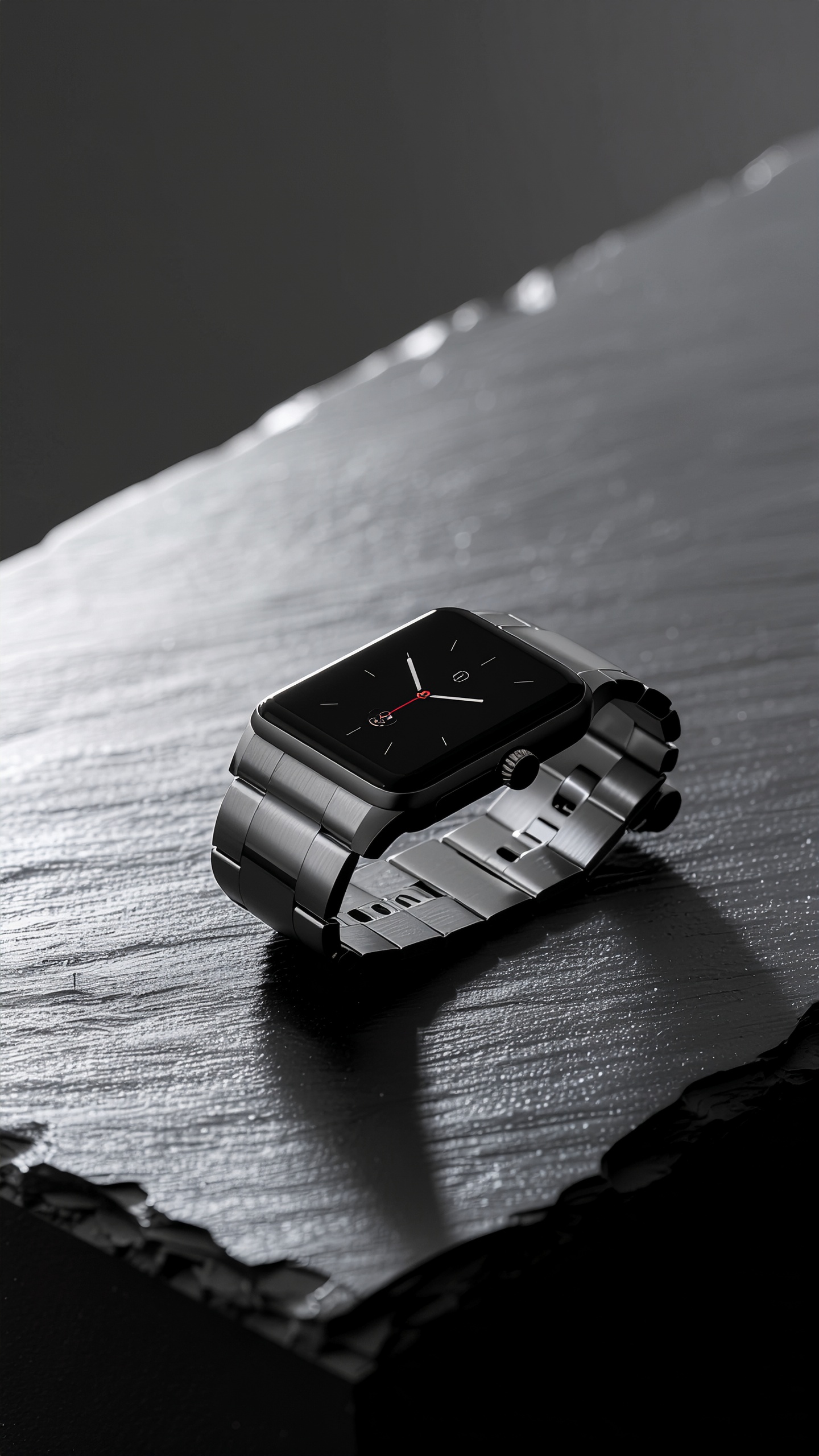 A sleek, modern smartwatch with a metallic band lies on a textured black surface