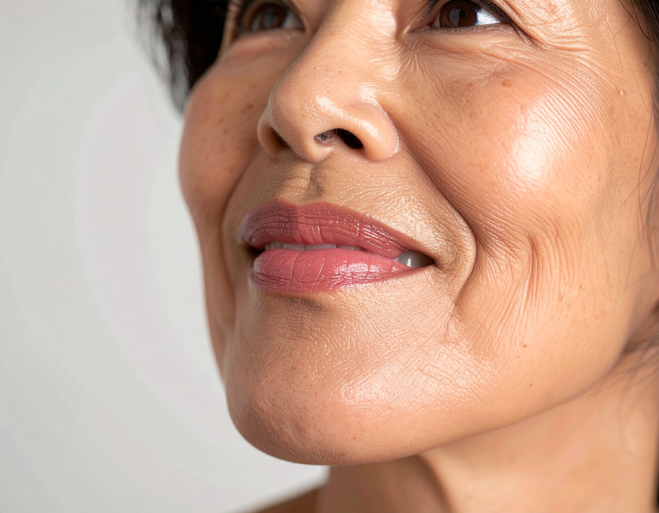 A close-up of a mature woman's face highlights natural beauty and aging gracefully