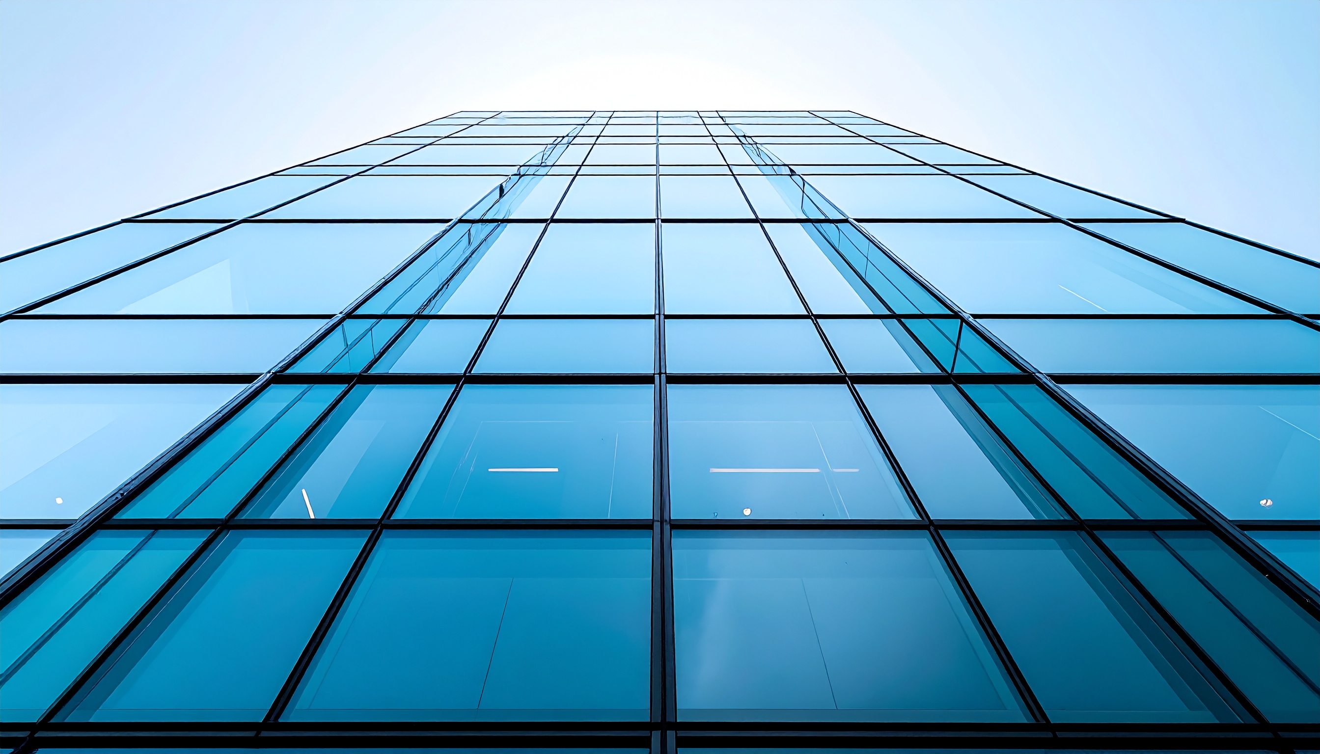 Glass Facade of a Skyscraper Reflecting Blue Sky