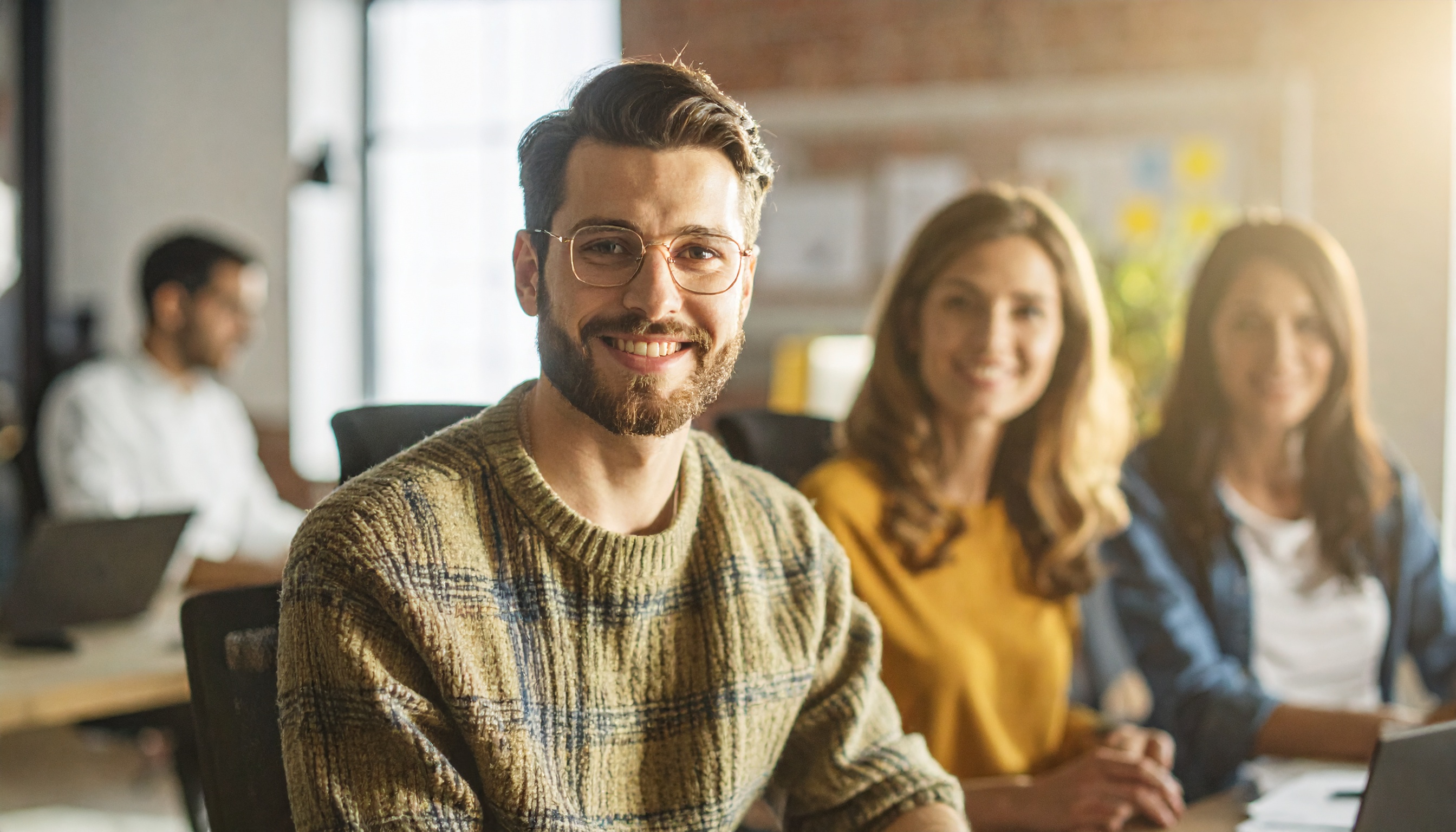 A group of young professionals in a modern office setting