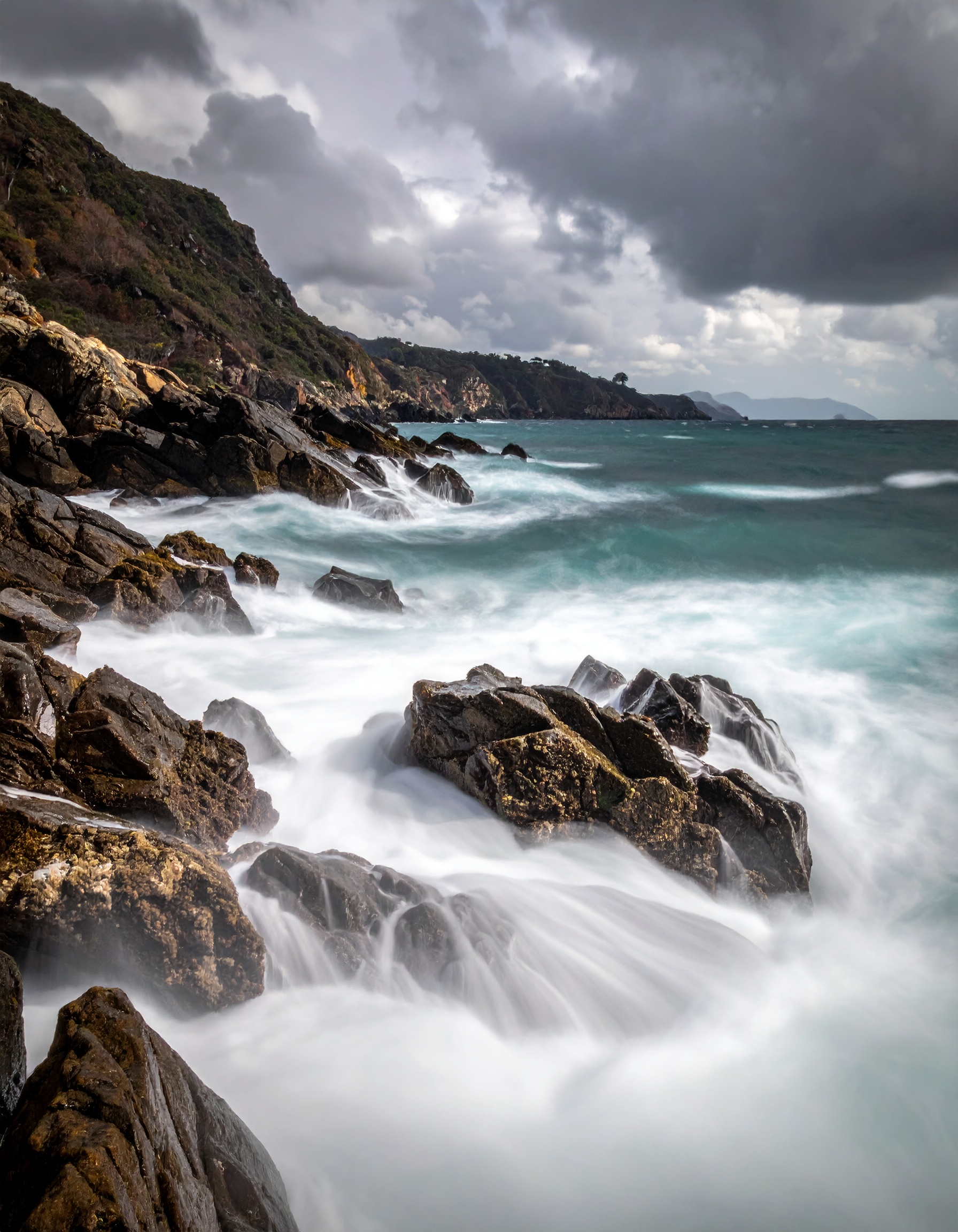 Dramatic coastal scene with waves crashing against rugged rocks