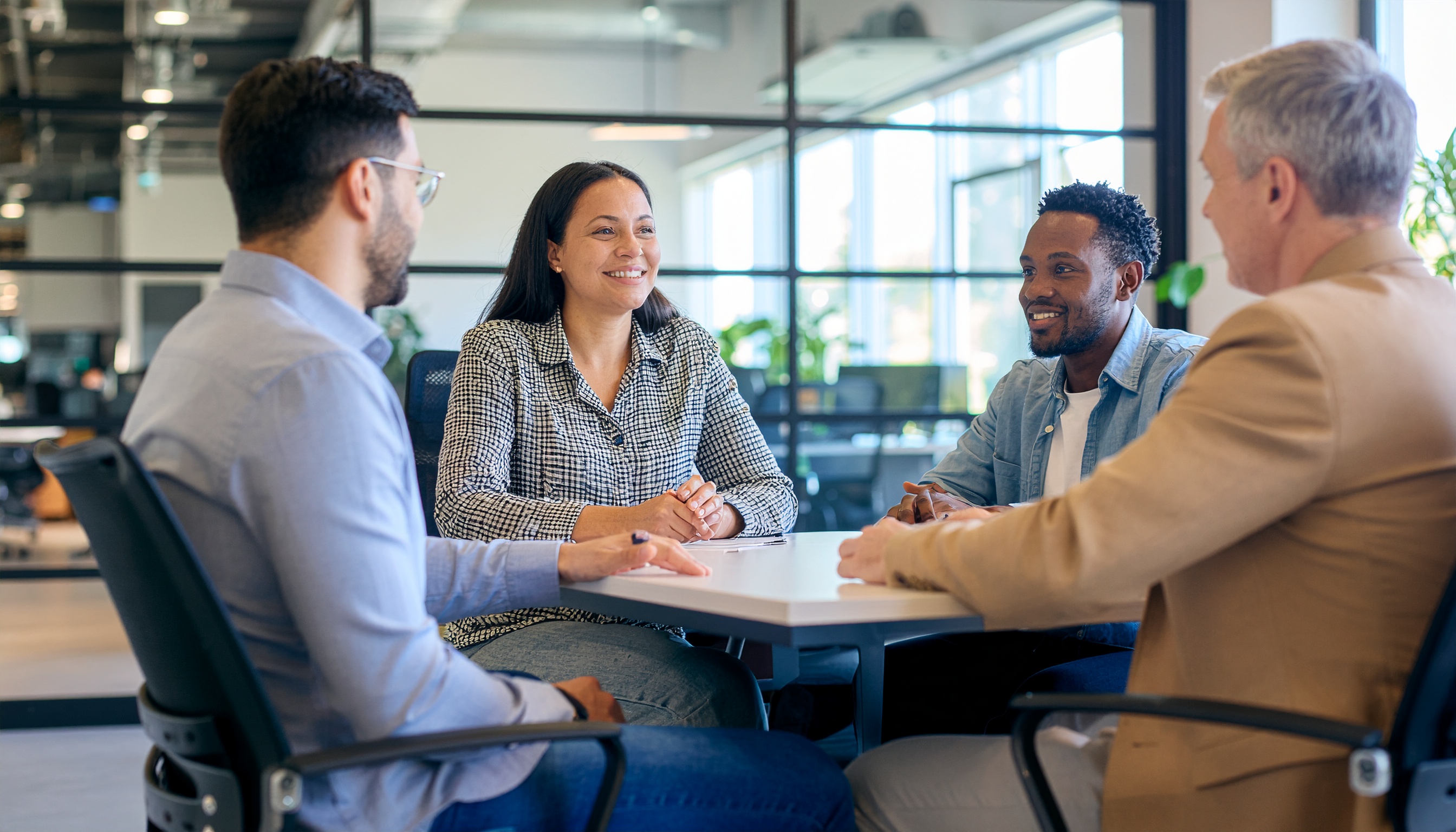Collaborative Meeting of Four People in Modern Office