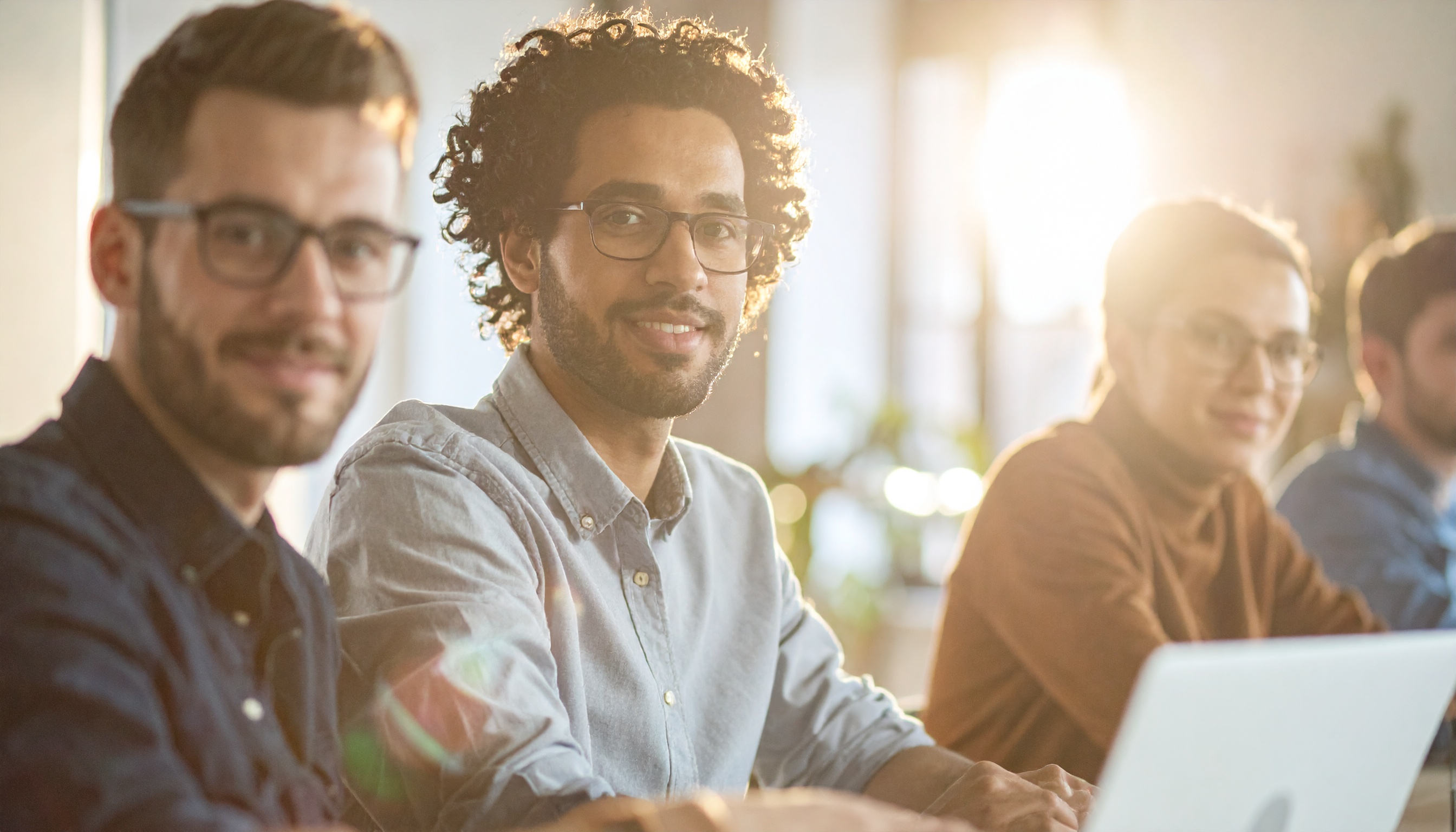 Group of professionals collaborating in a sunlit office space