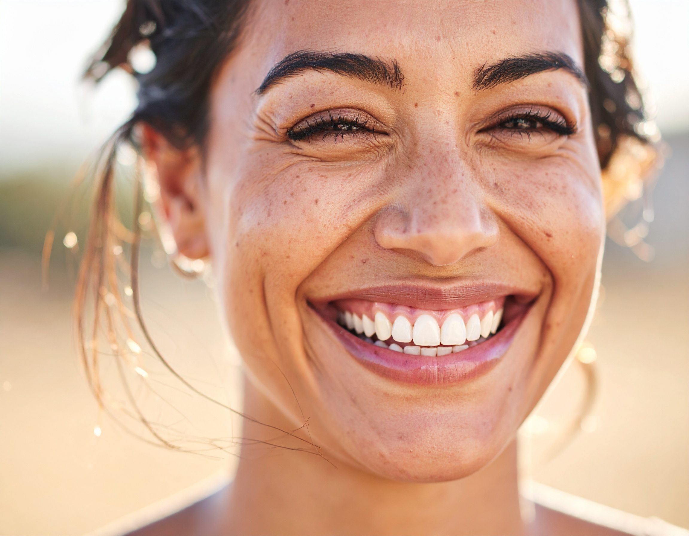 Bright smile of a woman with radiant skin in natural light
