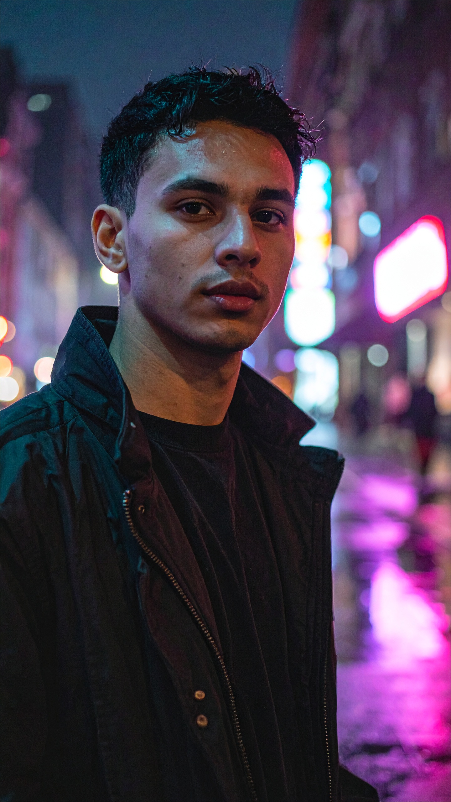 Young Man Portrait in Urban Night Scene with Neon Lights