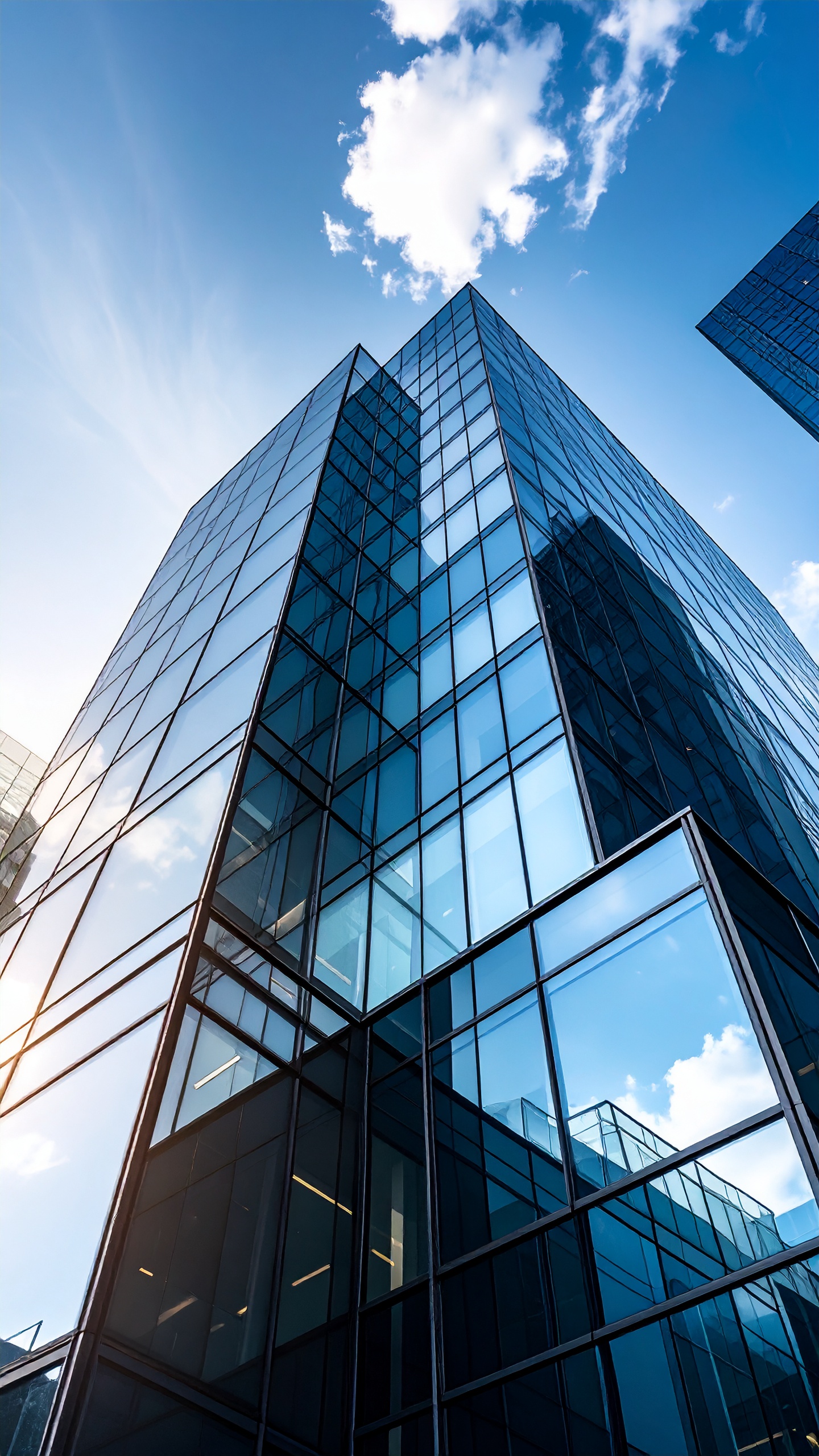 Modern Skyscraper with Glass Facade Reflecting Blue Sky