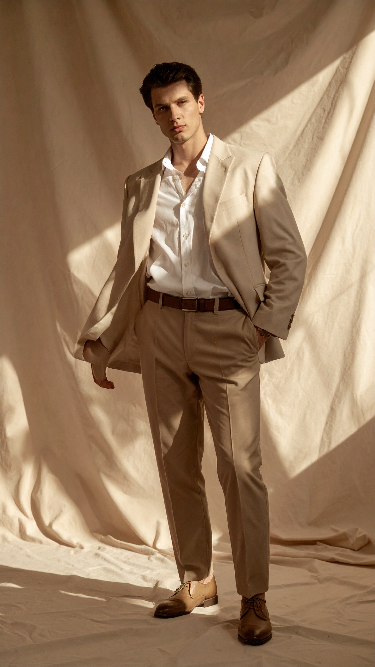 A man wears a stylish beige suit, perfect for formal occasions