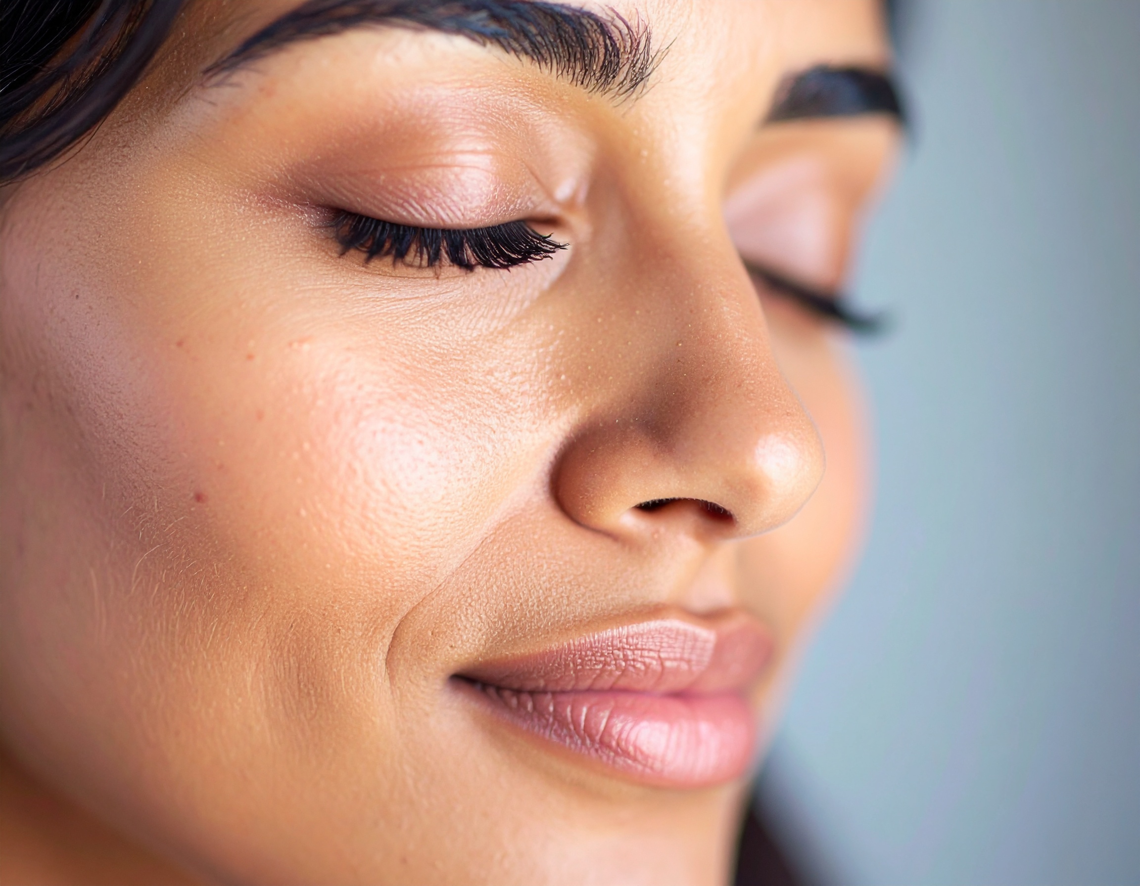 Close-up of a serene face with flawless skin and natural makeup