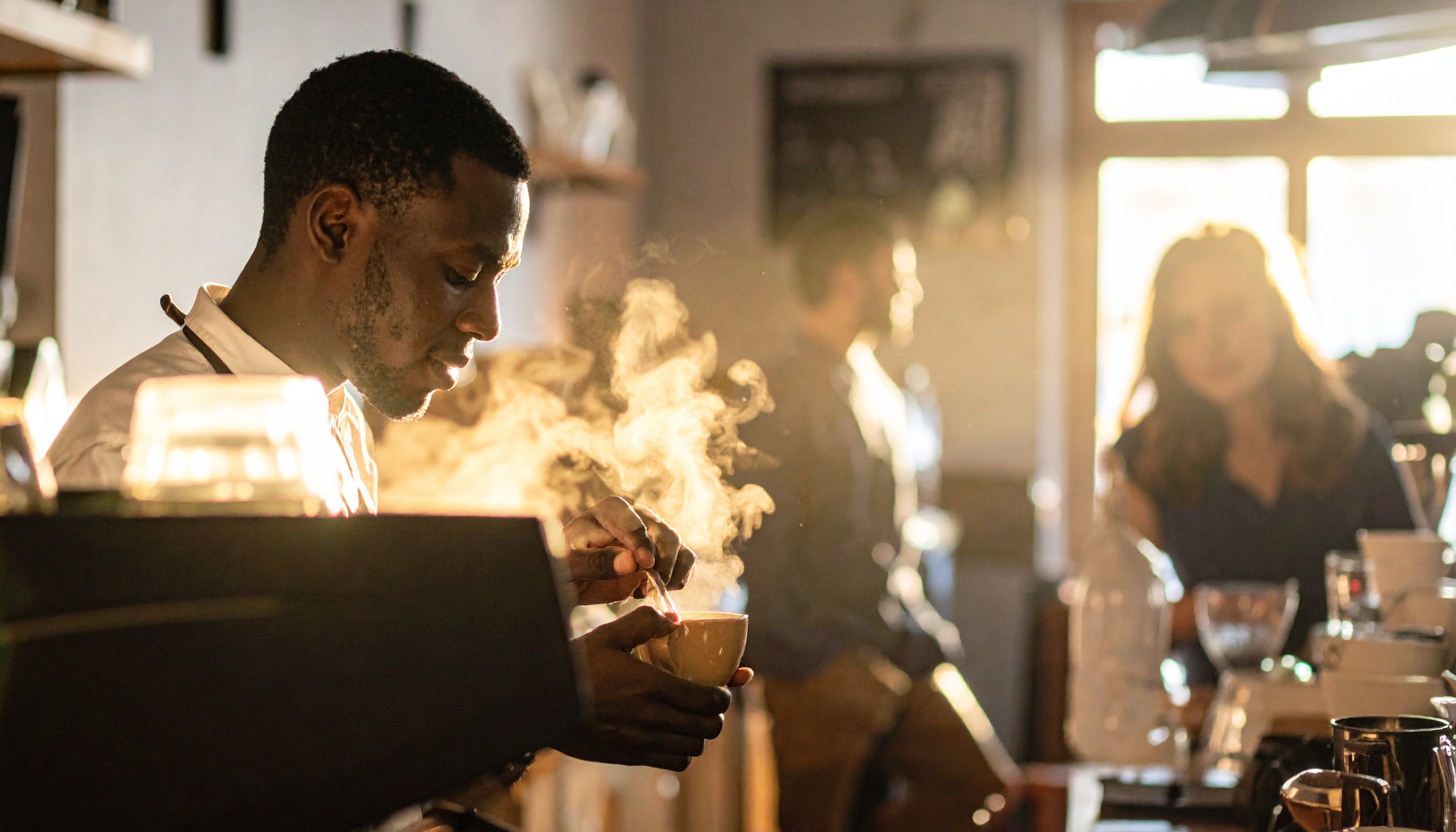 Barista Preparing Hot Drink in Sunlit Café