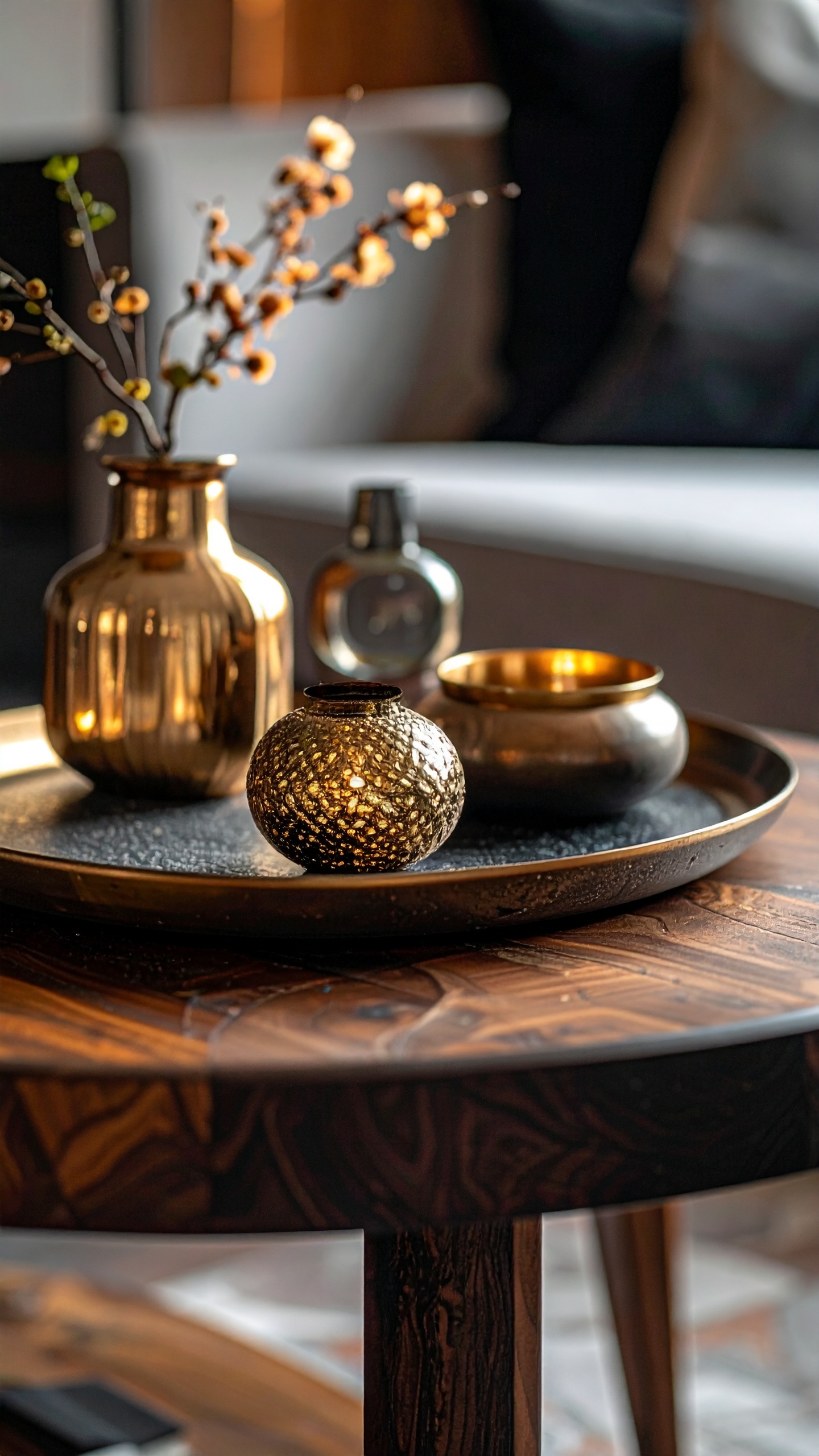 A golden vase and decorative items rest on a wooden table