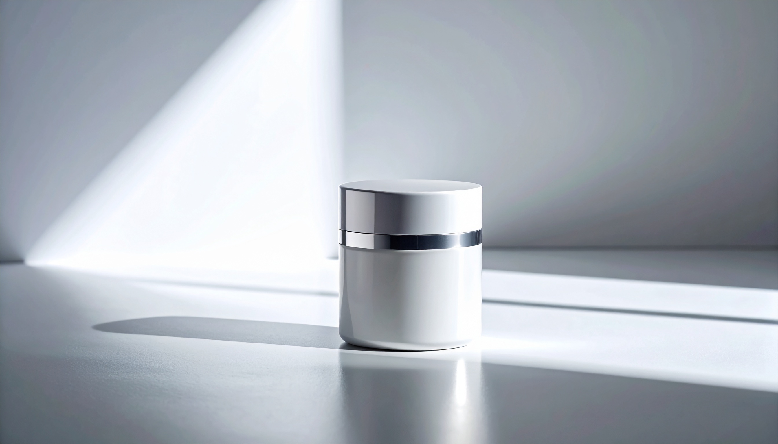 A sleek white cosmetic jar sits elegantly on a sunlit surface