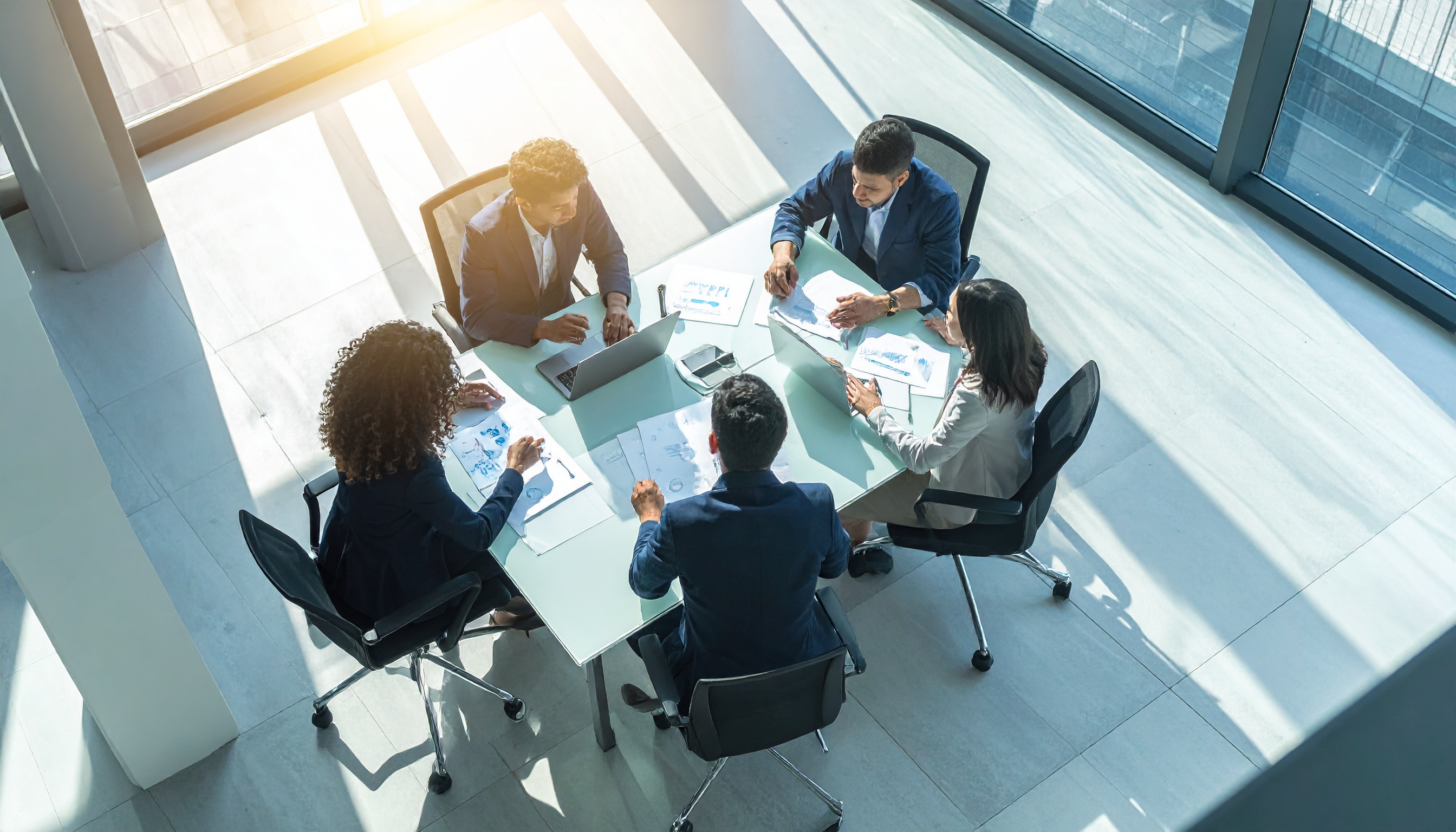 A team of professionals collaborates around a modern conference table