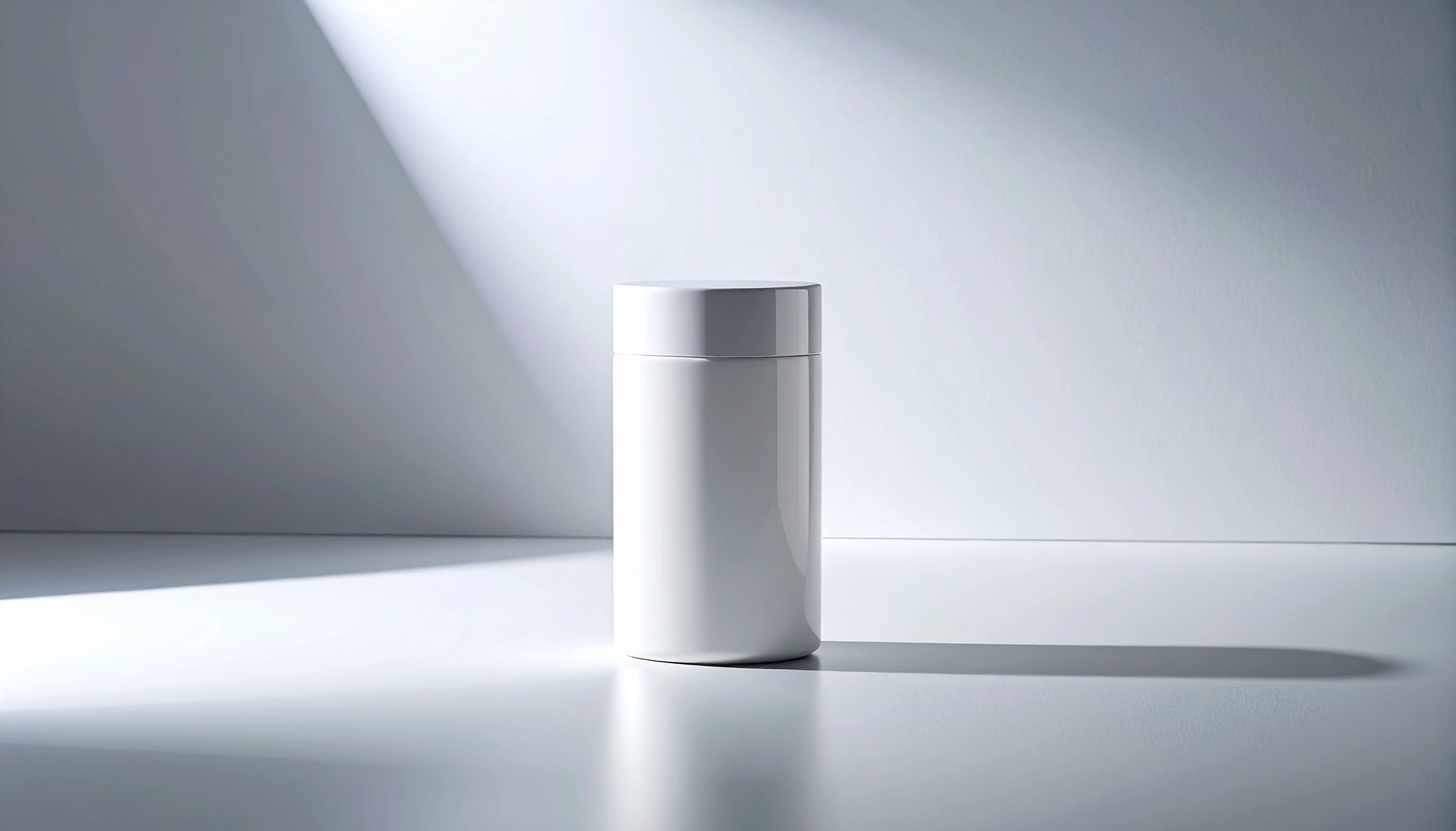 A sleek white cylindrical container sits elegantly on a smooth surface, bathed in soft lighting