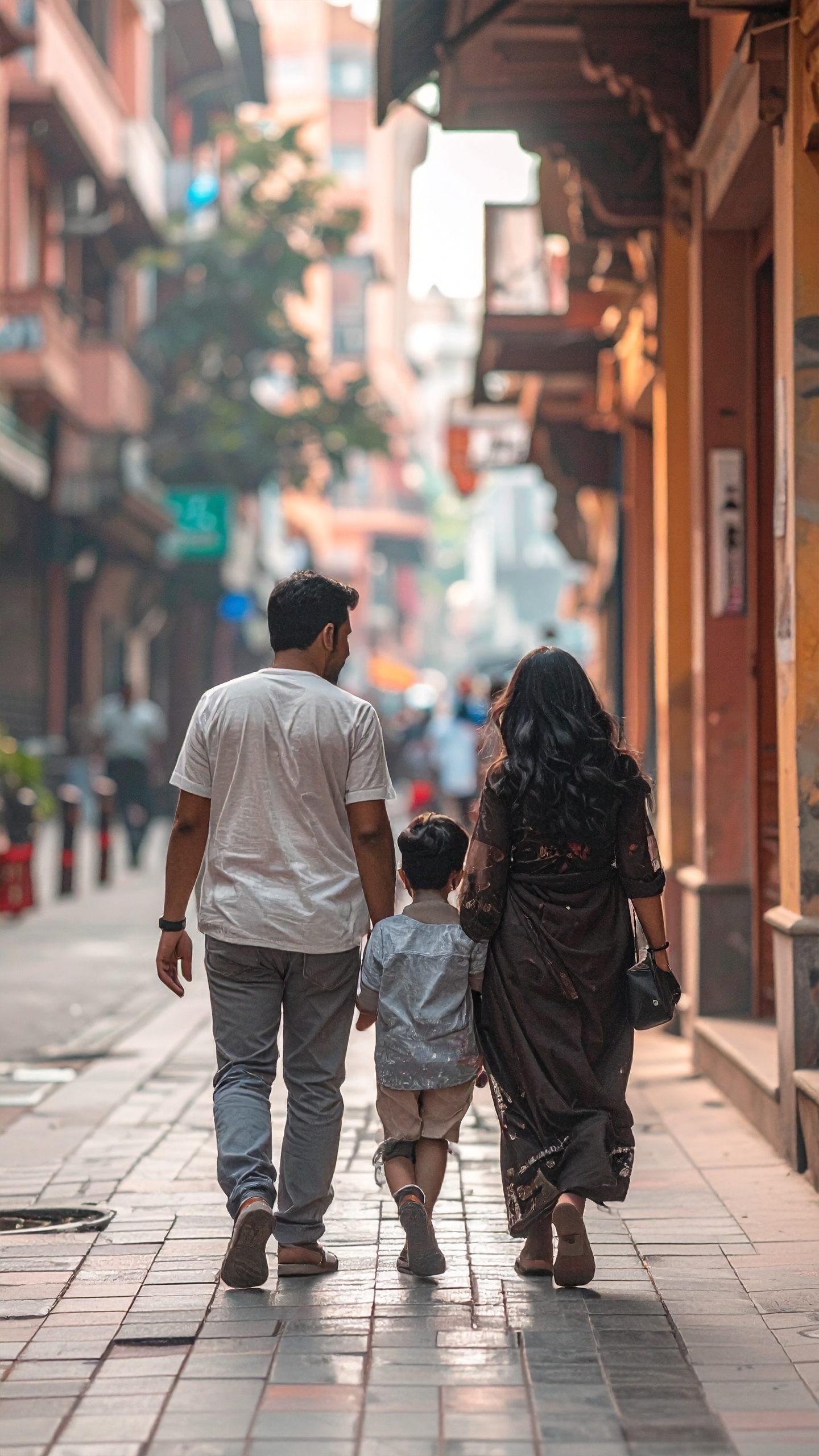 A family leisurely strolls through a vibrant city street