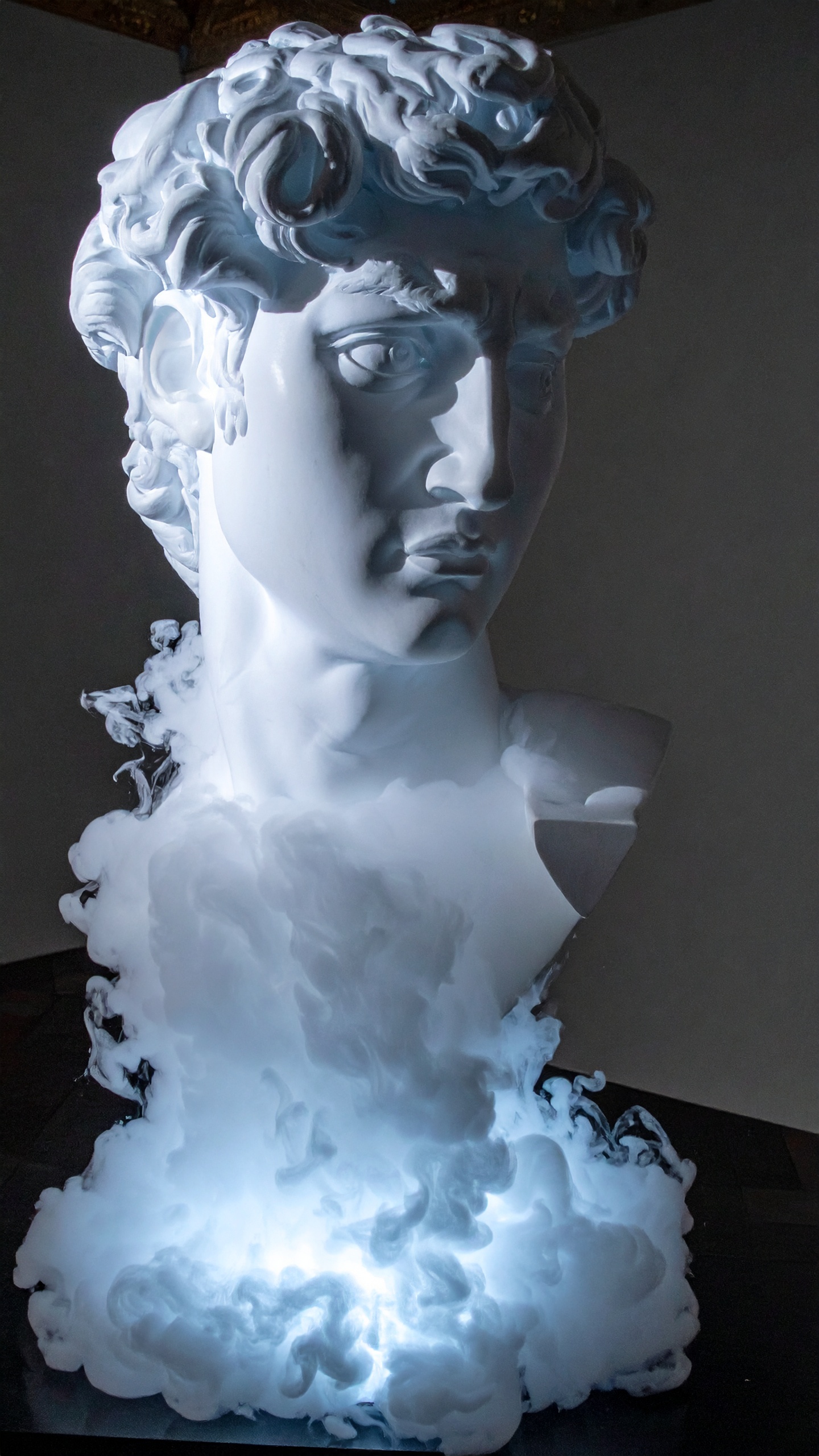 A luminous bust of David, shrouded in dramatic smoke, captivates the viewer