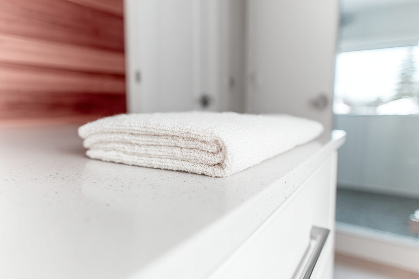 White Towel Folded on Light Counter in Minimalist Setting