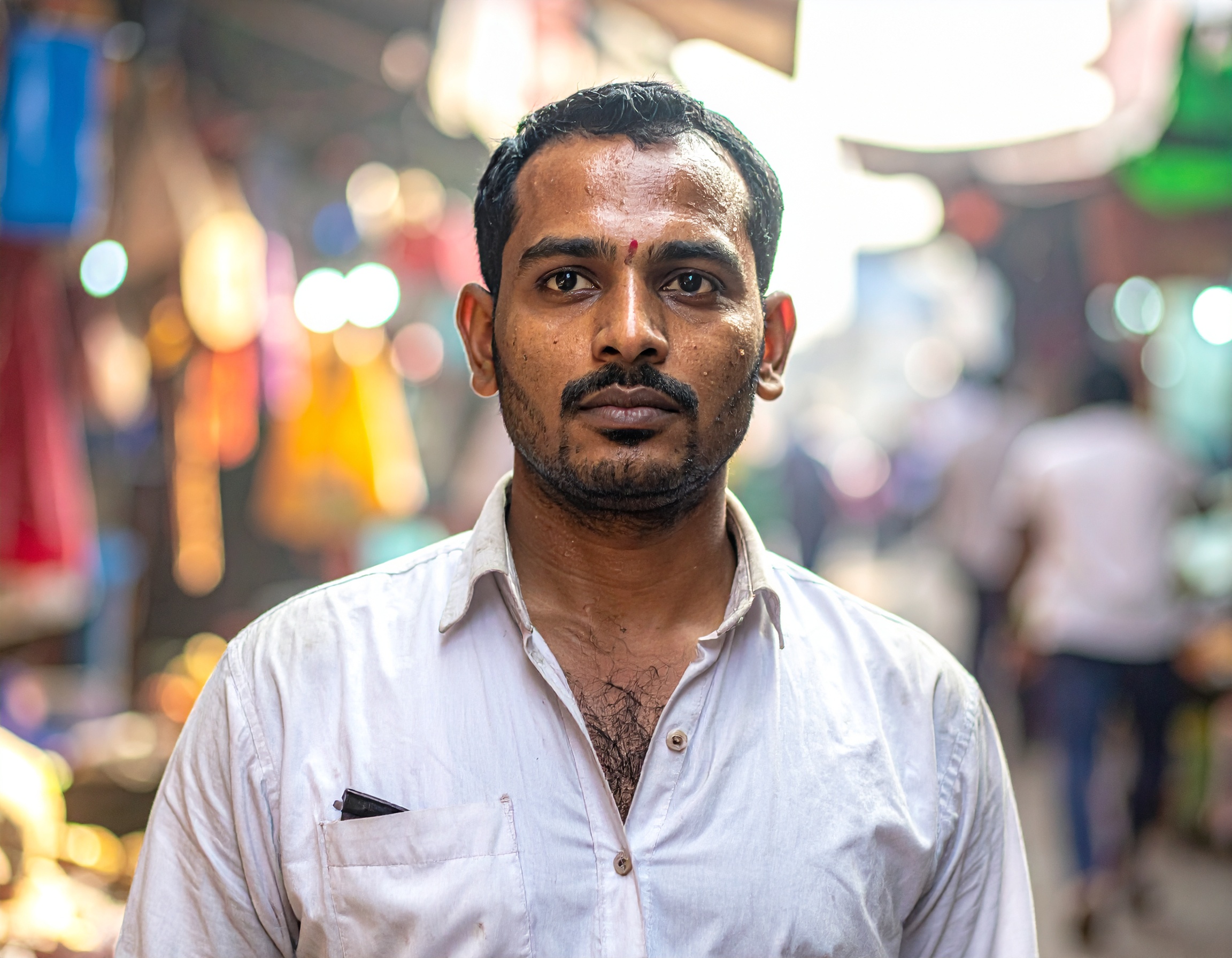 A person stands confidently in a bustling market setting