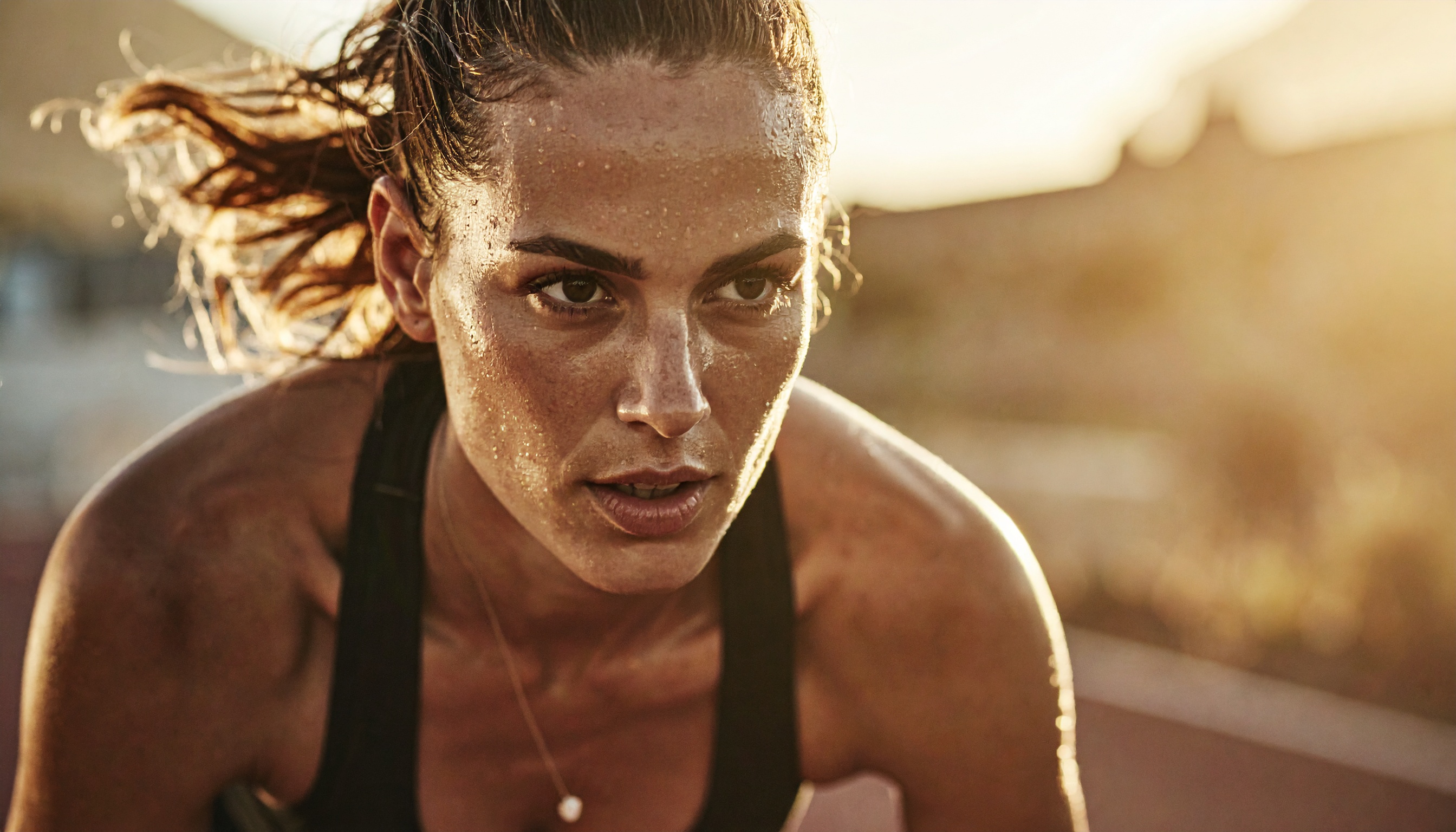 A determined athlete focuses intensely while running outdoors