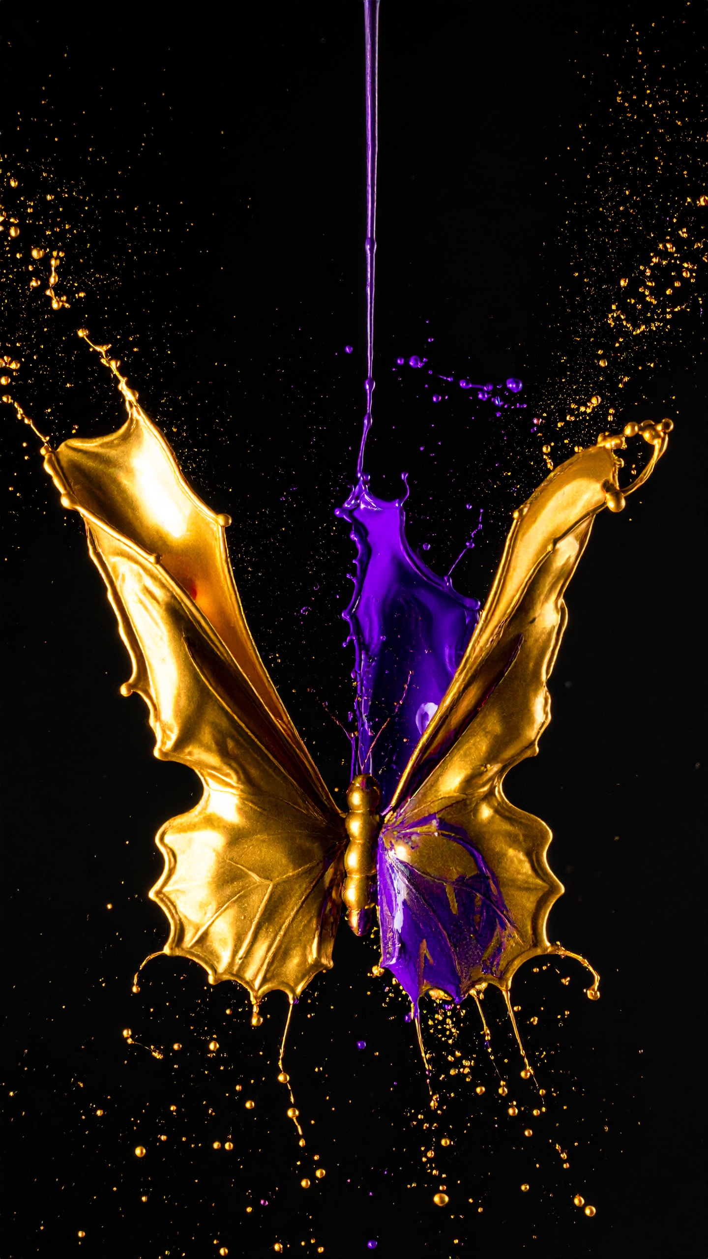 A mesmerizing butterfly shape is formed by golden and purple liquid splashes against a black